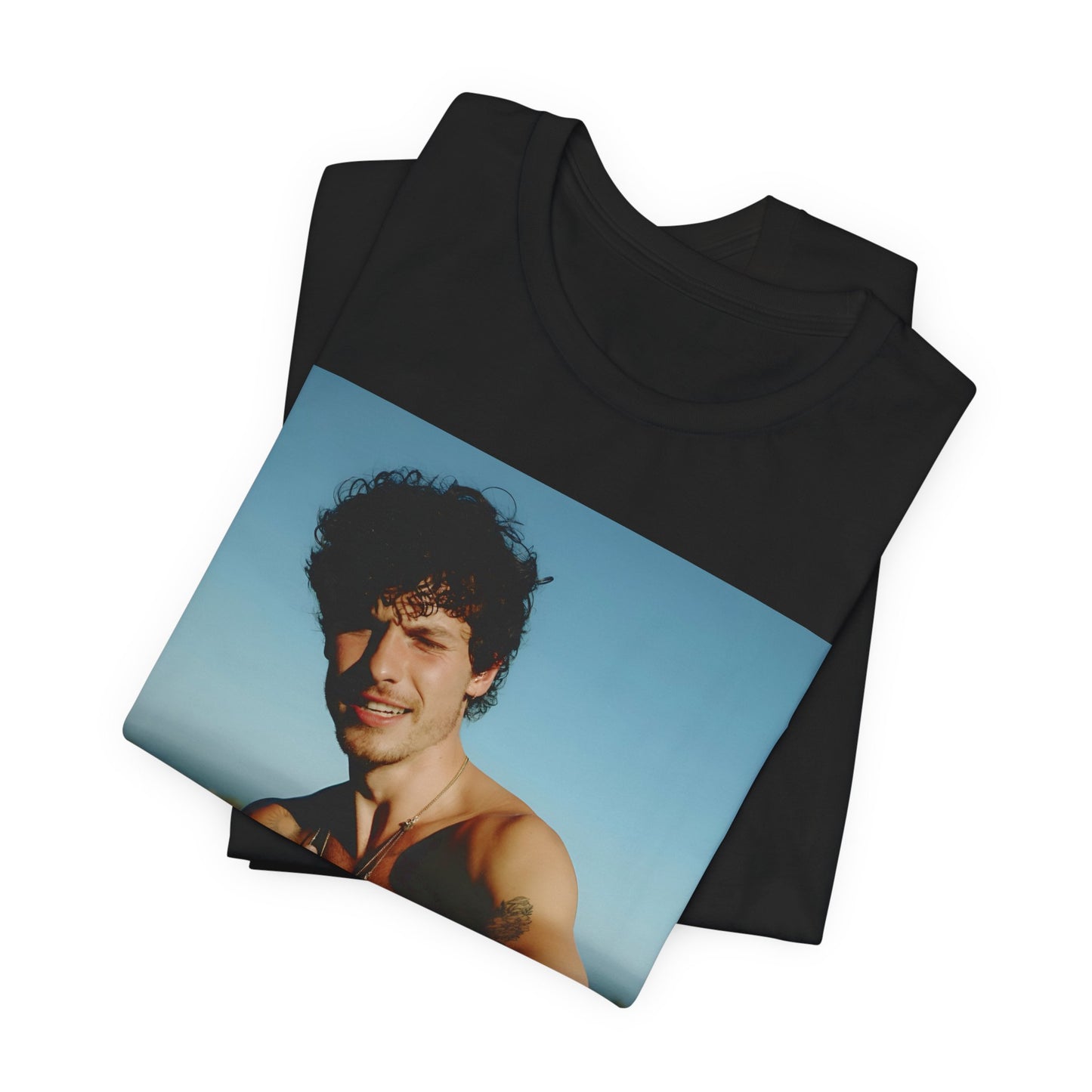 A black graphic t-shirt featuring a graphic of Shawn Mendes with a chill pop star look.