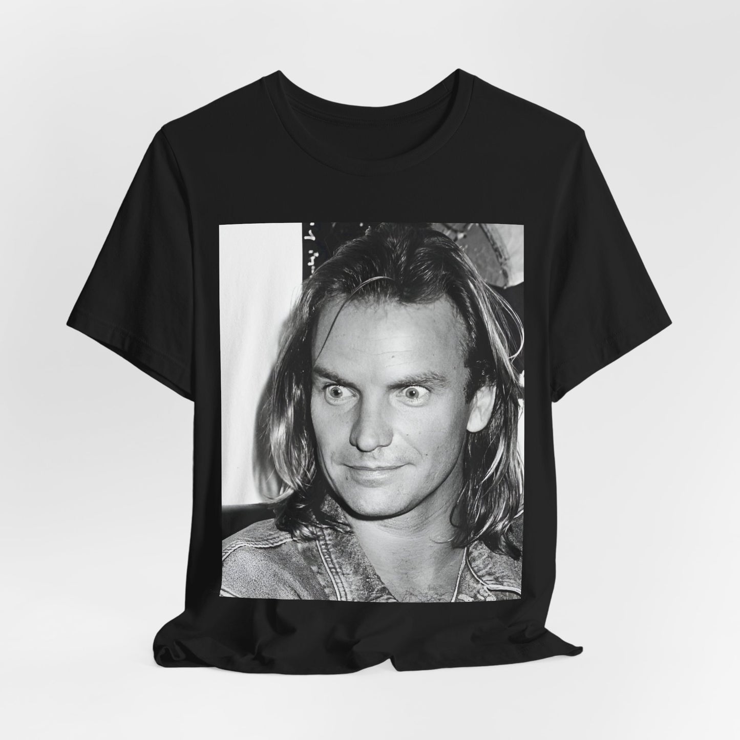 A black graphic t-shirt featuring a retro graphic related to Sting's 'Synchronicity' album era.