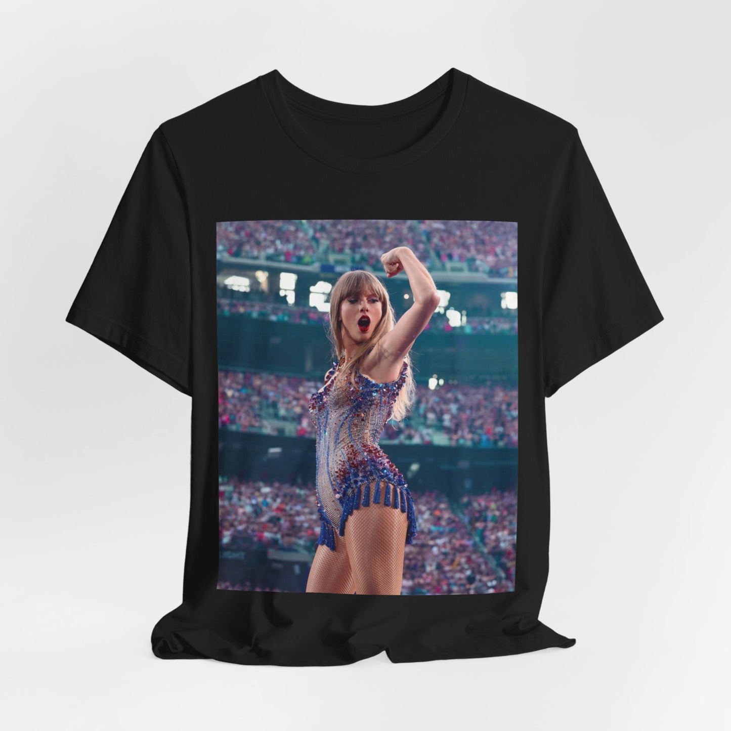 A black graphic t-shirt featuring a graphic or photo of Taylor Swift performing live on stage.