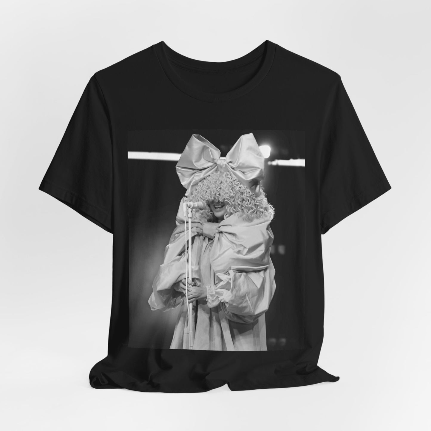 A black graphic t-shirt featuring a black and white, monochrome graphic or photo of Sia.