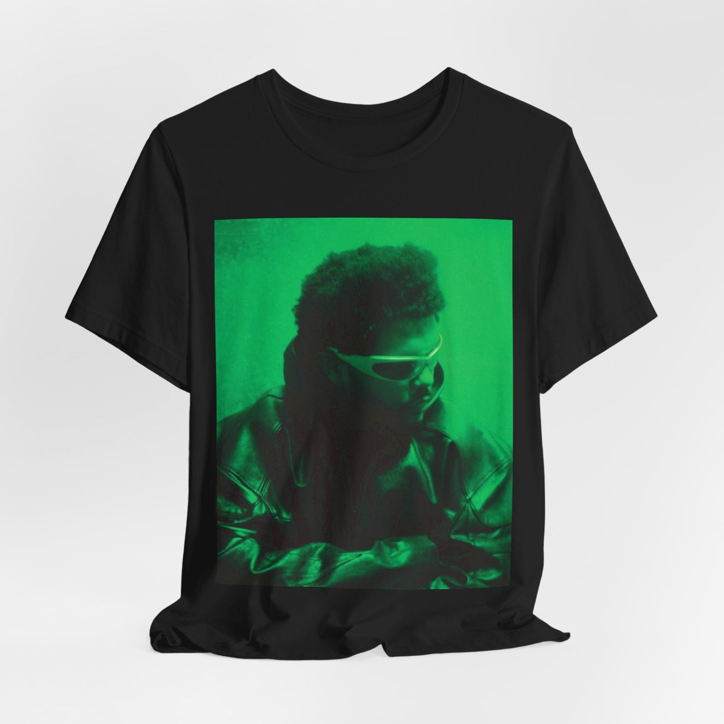 A black graphic t-shirt featuring a vintage graphic related to The Weeknd's 'Kiss Land' era.