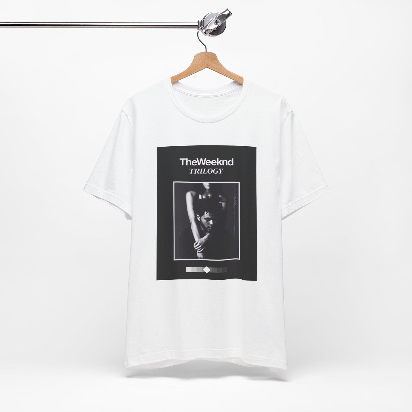 A black graphic t-shirt featuring a graphic related to The Weeknd's 'Trilogy' album.