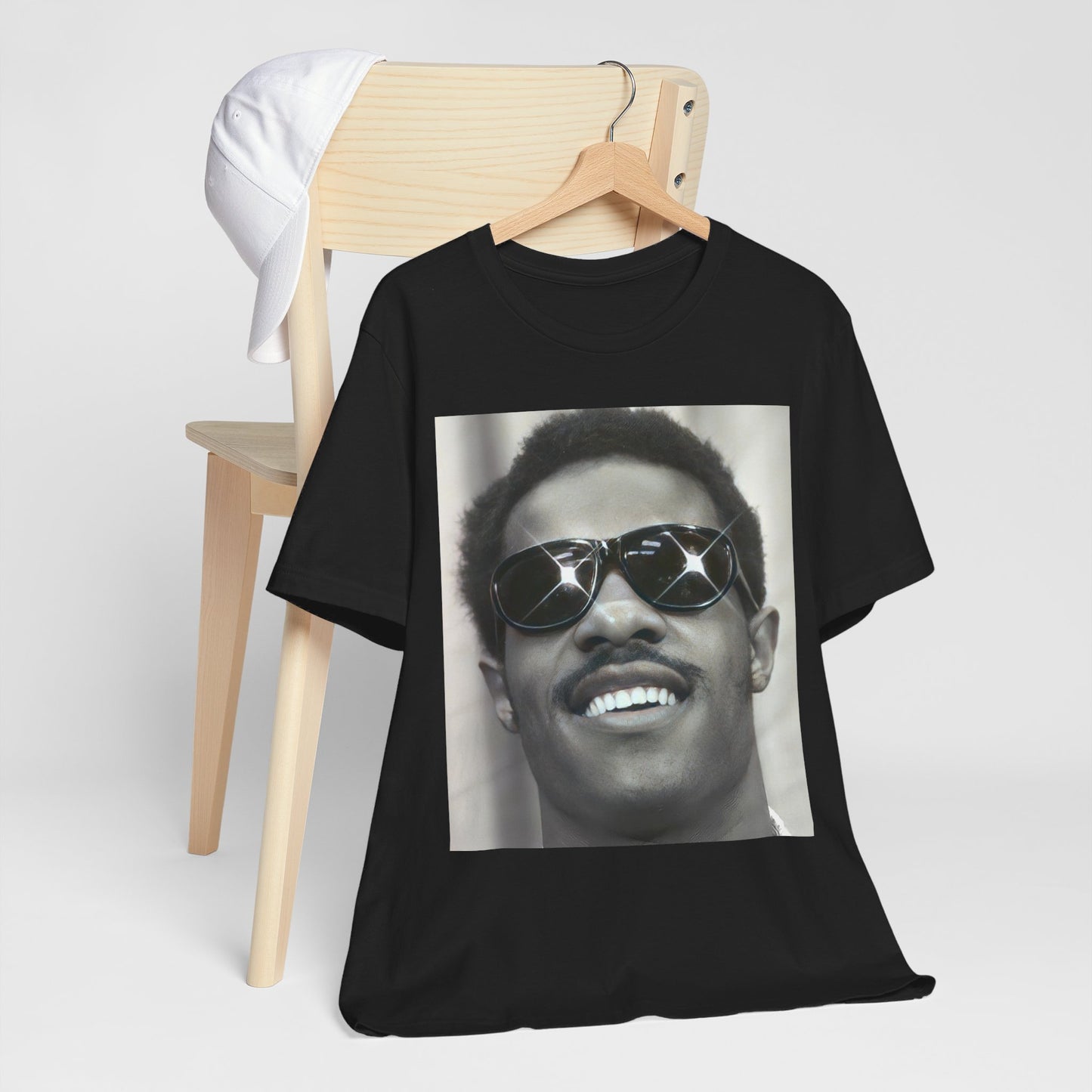 A black graphic t-shirt featuring a 70s funk aesthetic black and white graphic or photo of Stevie Wonder.