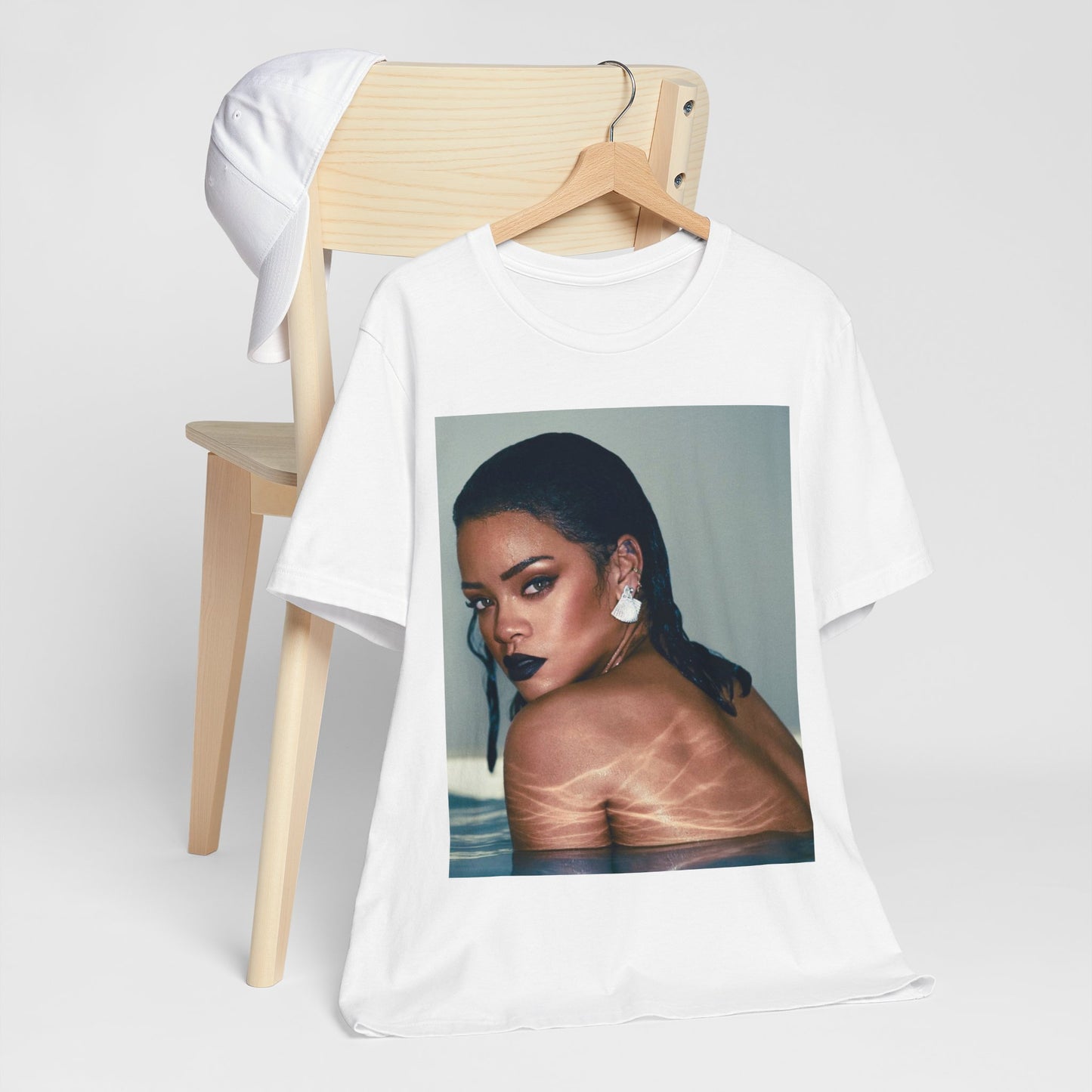 A black graphic t-shirt featuring a vintage pop icon graphic of Rihanna.