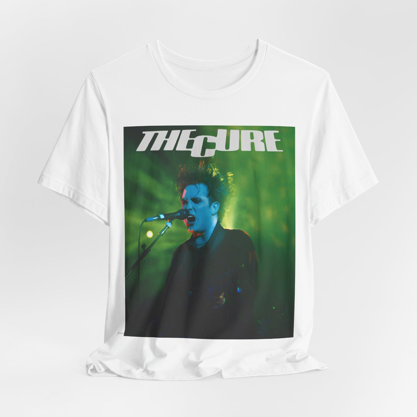 A black graphic t-shirt featuring a graphic or photo of The Cure performing live on stage.