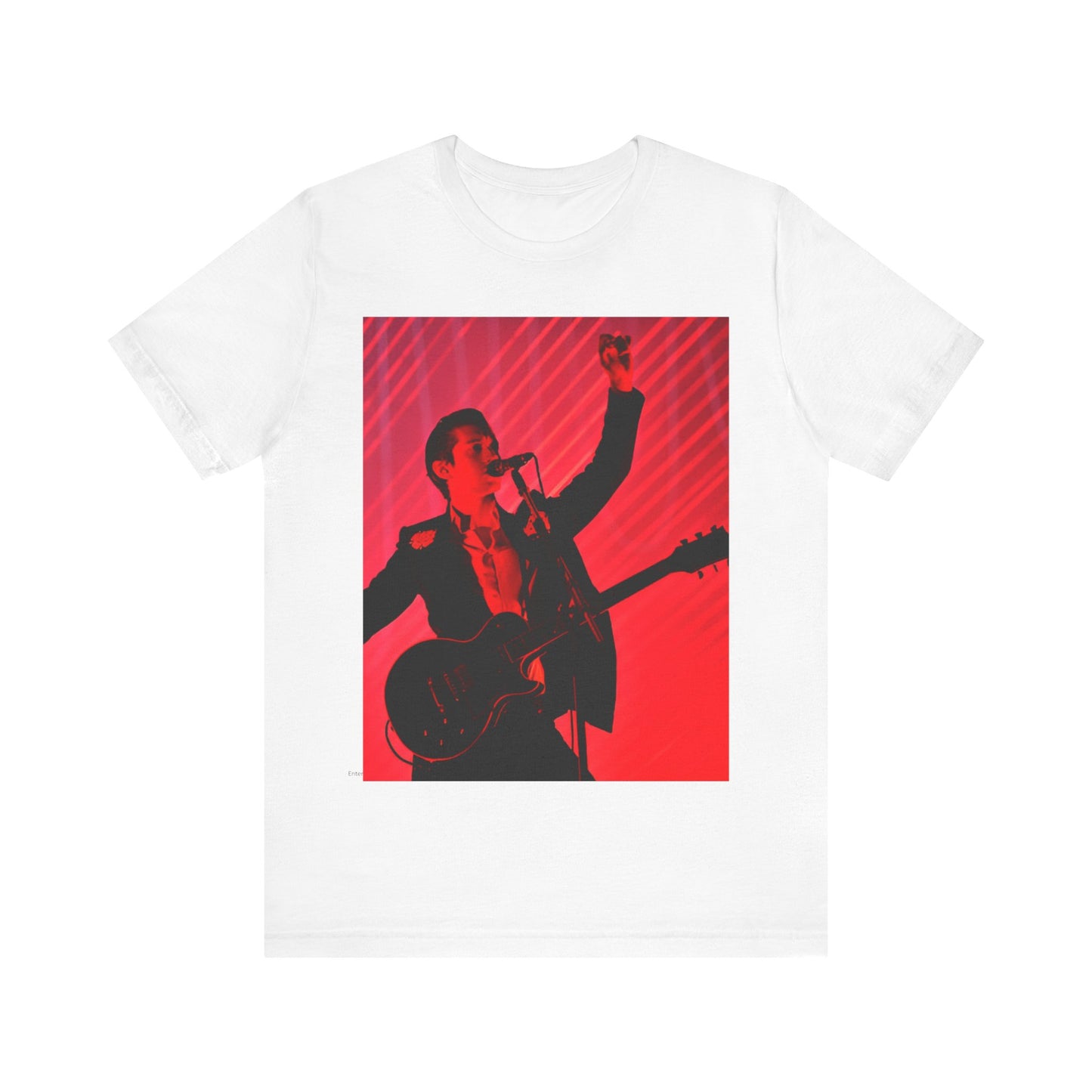 A black graphic t-shirt featuring a dynamic graphic or photo of Arctic Monkeys performing live in concert.