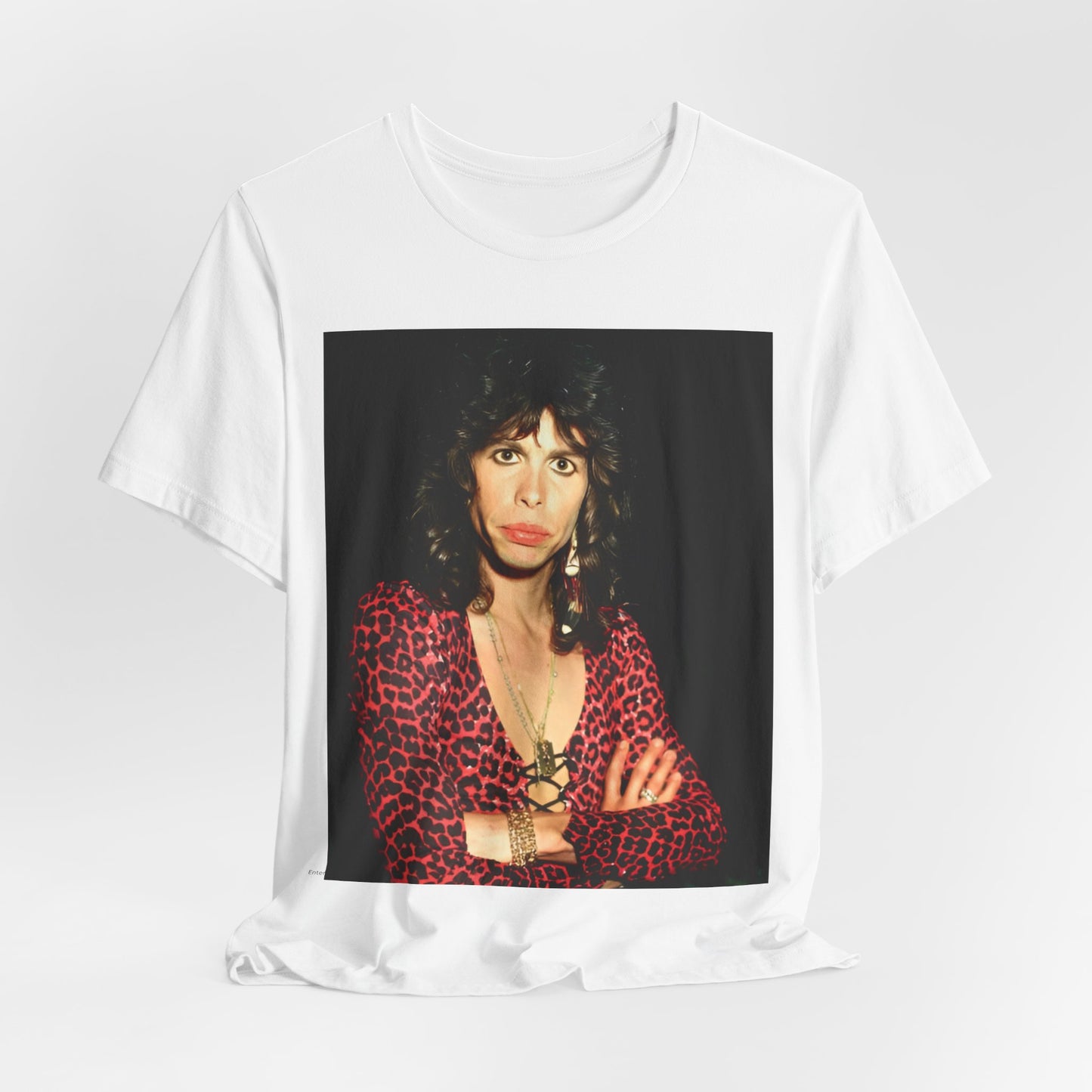 A black graphic t-shirt featuring a vintage 70s-inspired design with Aerosmith branding, incorporating a prominent leopard print pattern.
