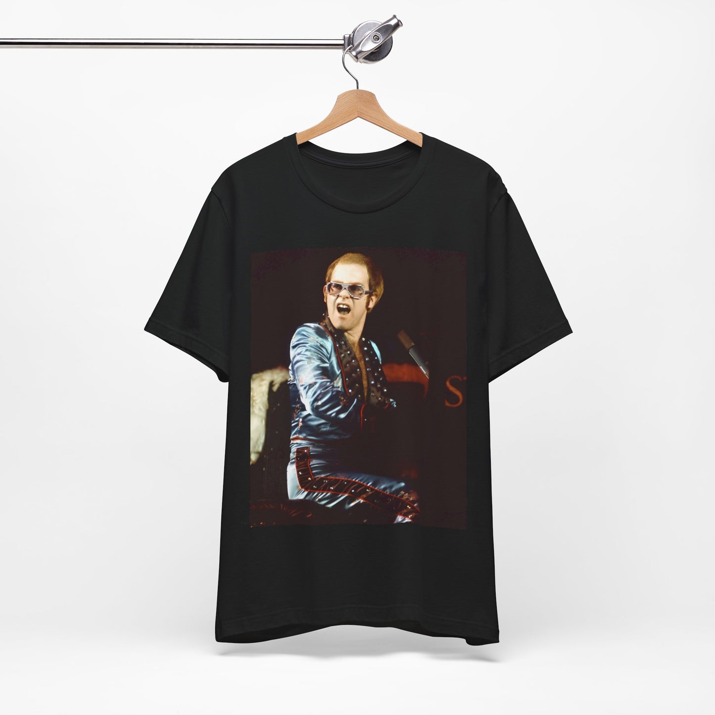 A black graphic t-shirt featuring a retro graphic related to Elton John's 'Rocket Man' song or era.
