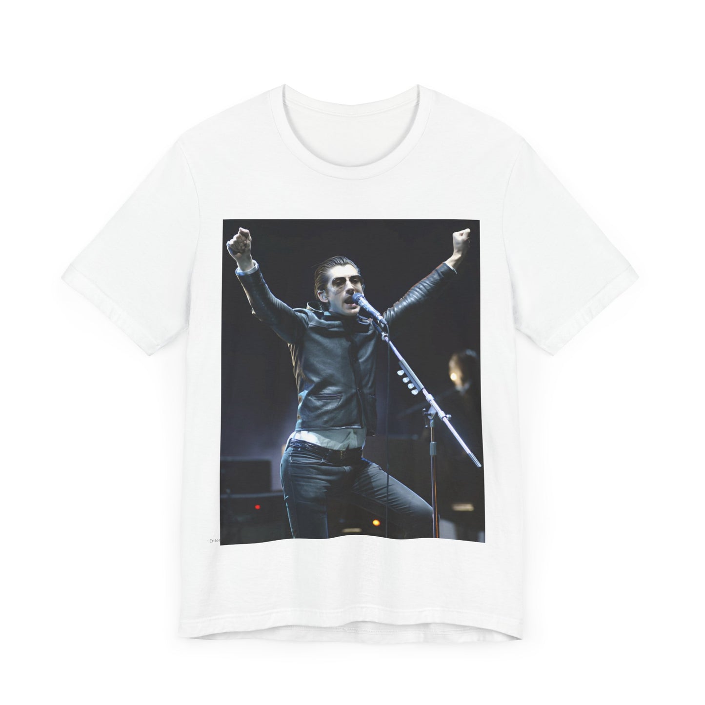 A black graphic t-shirt featuring a graphic or photo of Arctic Monkeys performing live on stage, with a Britpop aesthetic.