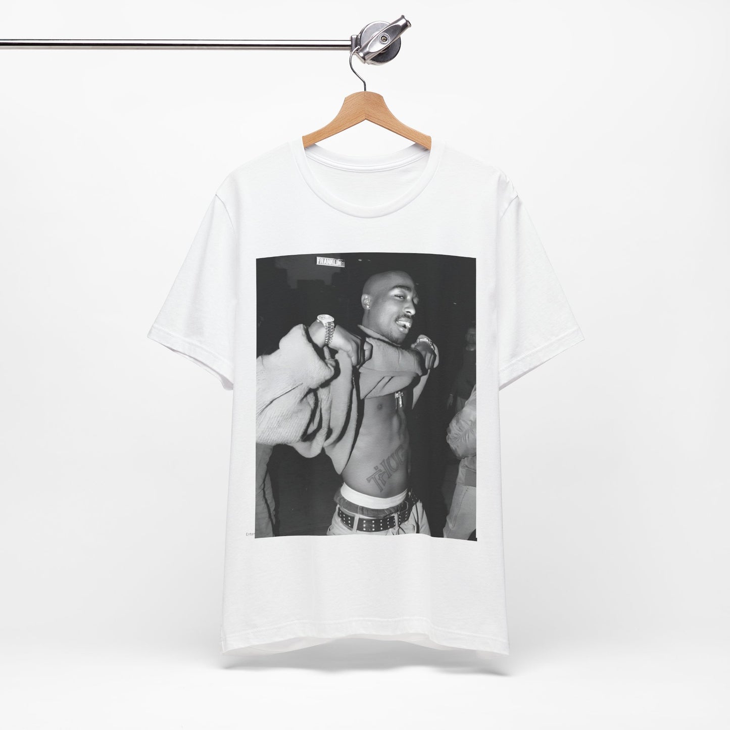 A black graphic t-shirt featuring a vintage hip hop icon graphic of Tupac.