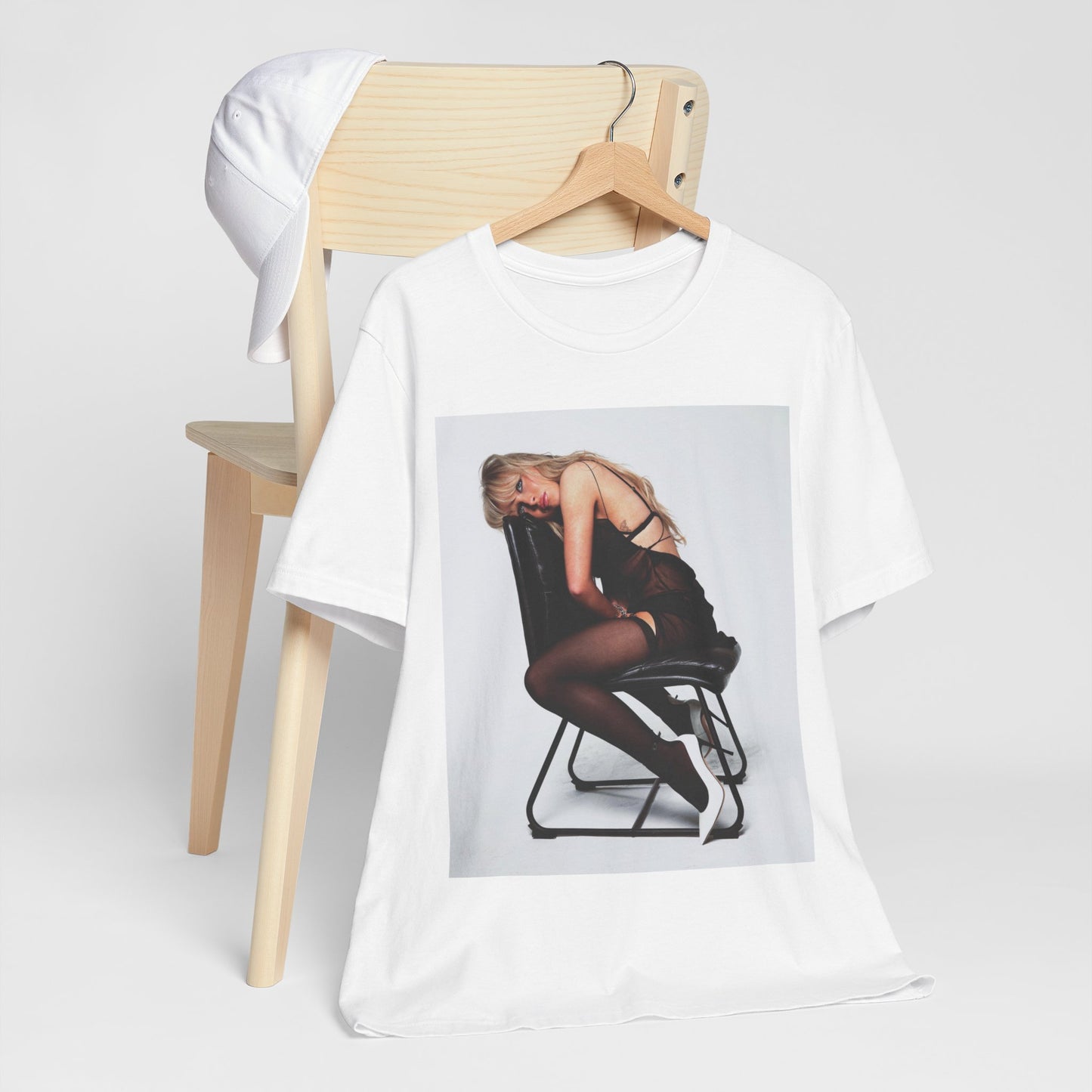 A black graphic t-shirt featuring a playful pop art style graphic of Sabrina Carpenter.
