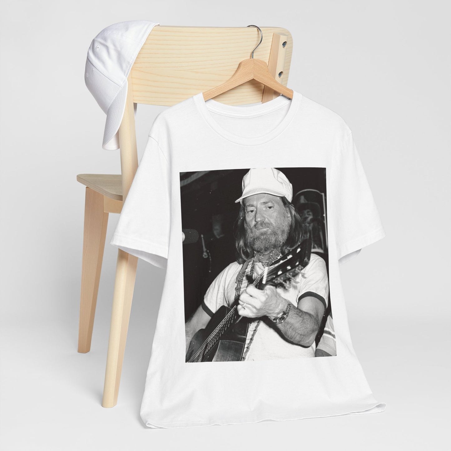 A black graphic t-shirt featuring a 70s cool free spirit graphic of Willie Nelson.