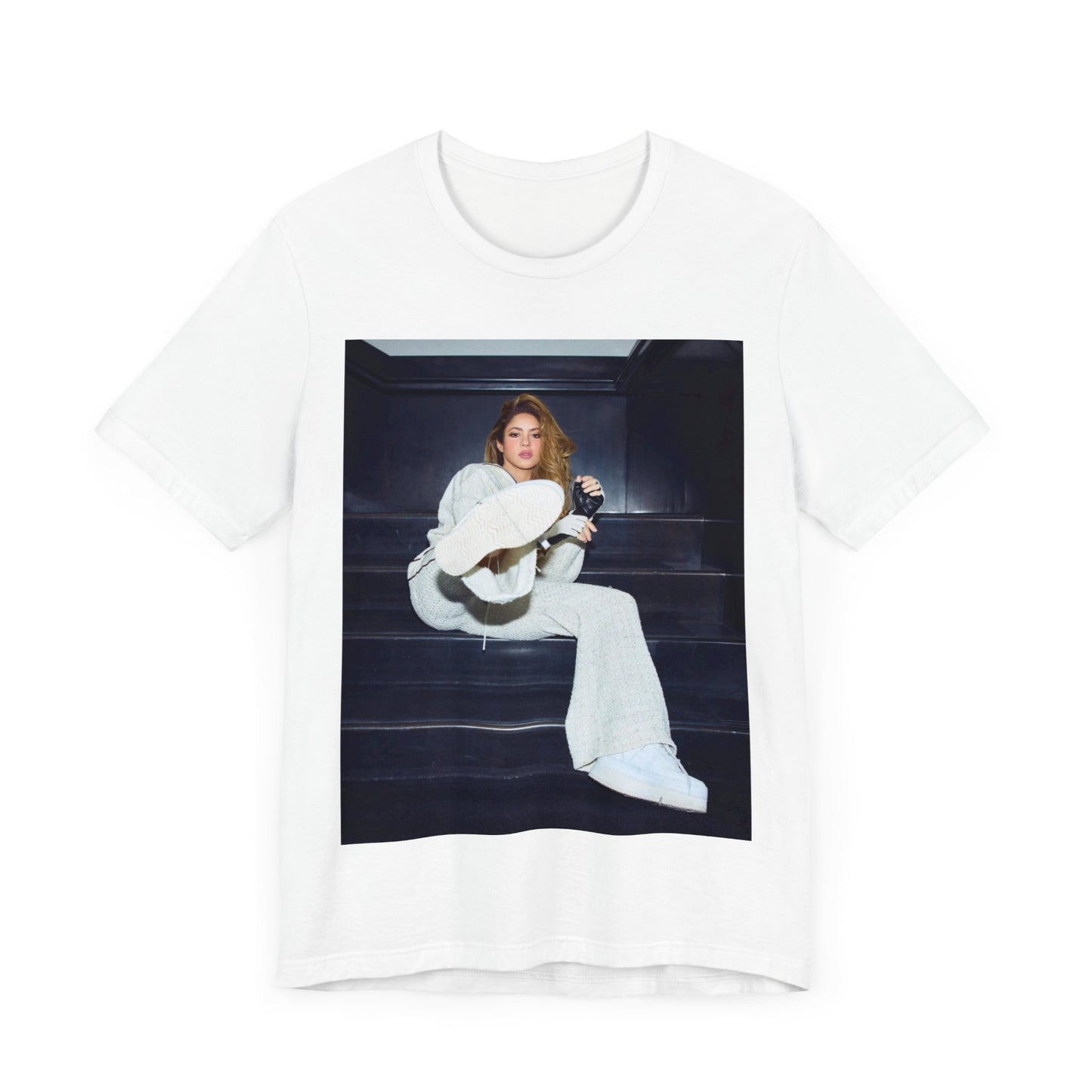 A black graphic t-shirt featuring a vintage Latin pop icon graphic of Shakira.