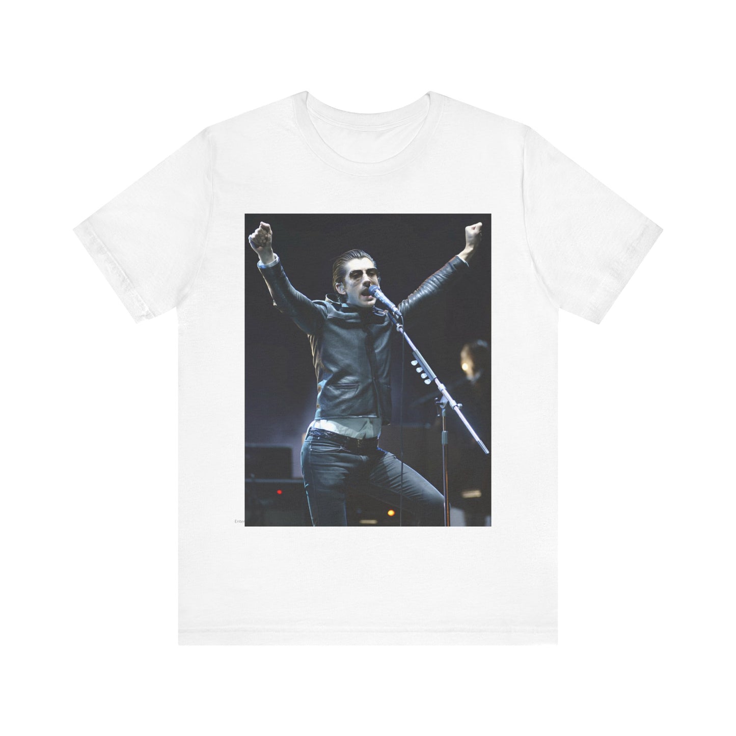 A black graphic t-shirt featuring a graphic or photo of Arctic Monkeys performing live on stage, with a Britpop aesthetic.