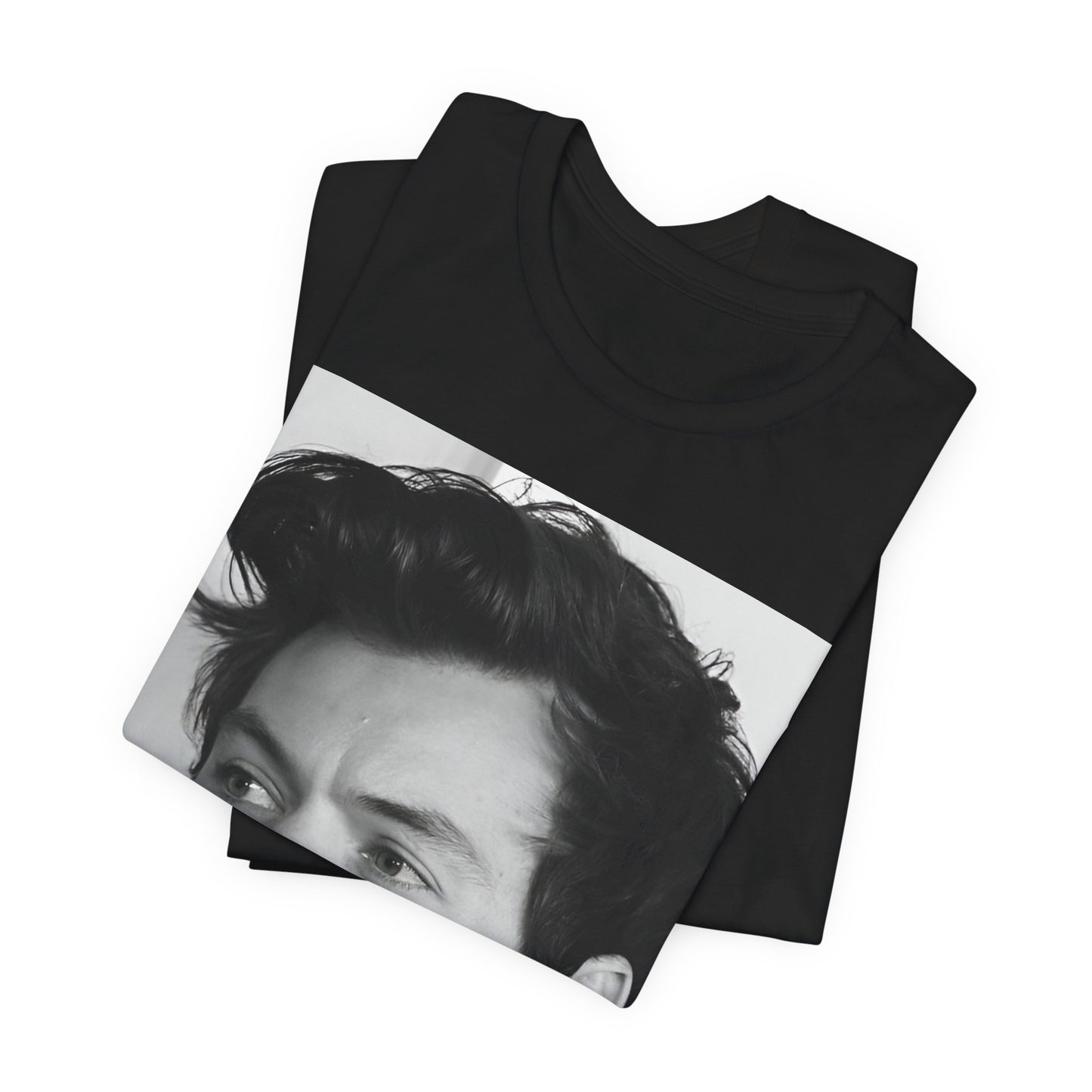 A black graphic t-shirt featuring a black and white, monochrome graphic or photo of Harry Styles.