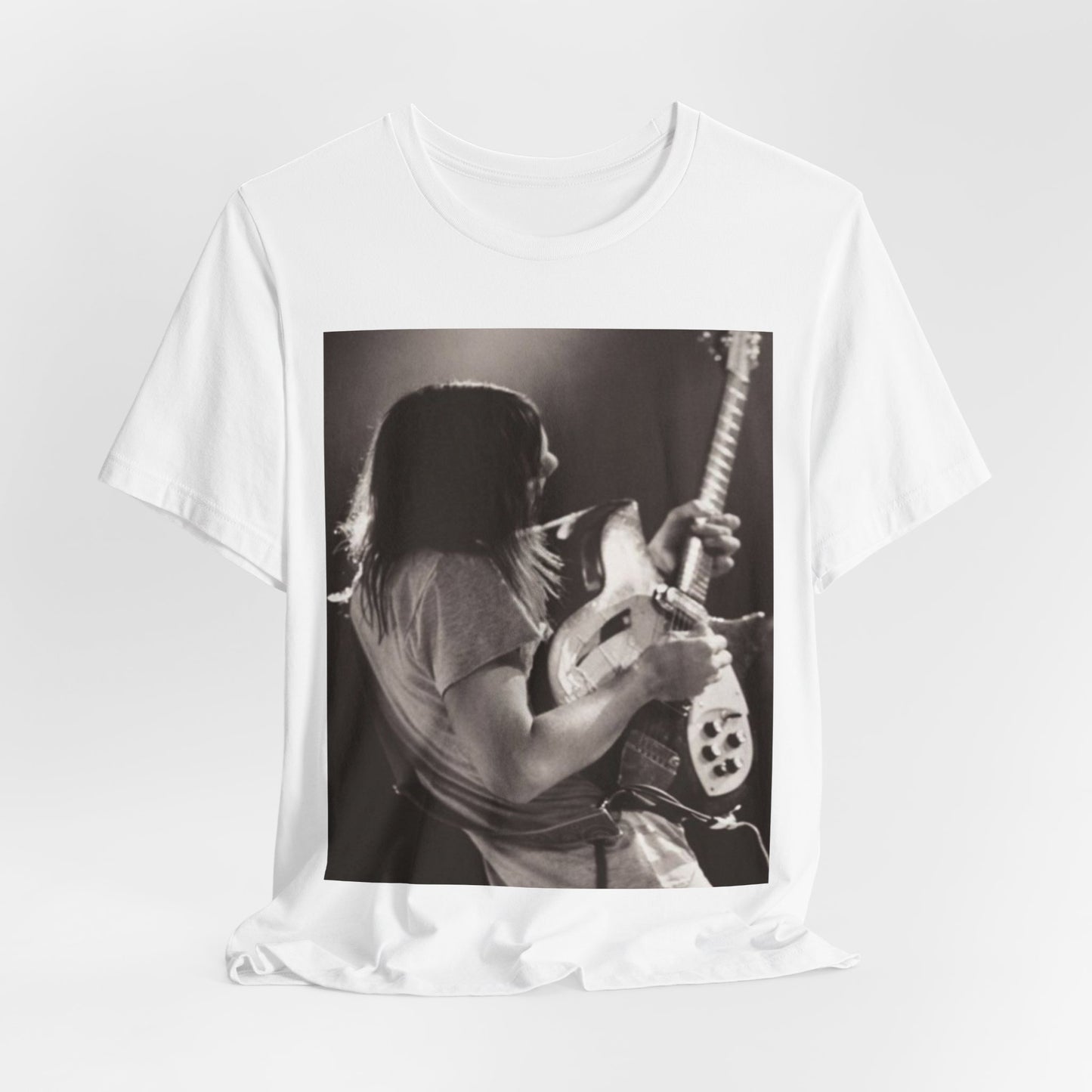 A black graphic t-shirt featuring a black and white graphic or photo of Tame Impala performing live on stage.