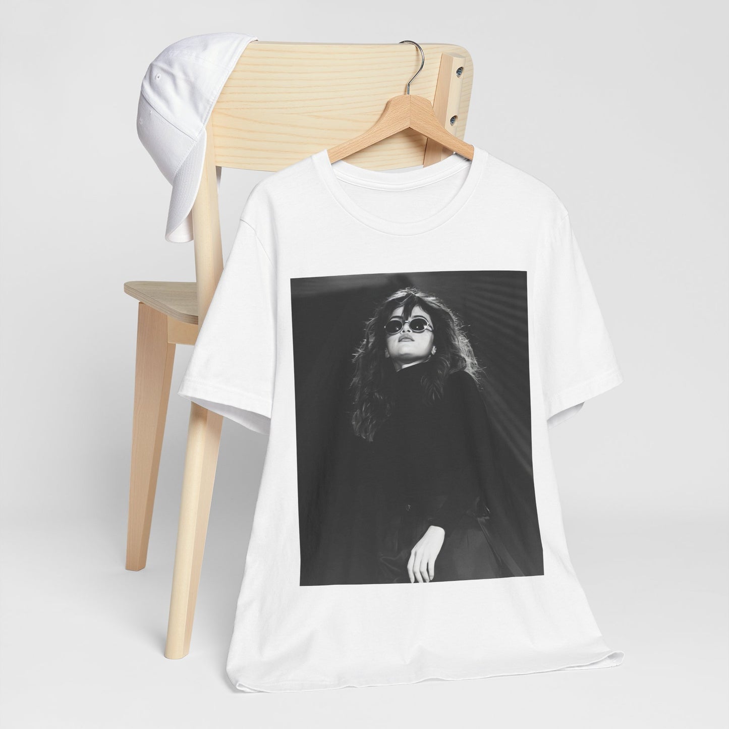 A black graphic t-shirt featuring a black and white, monochrome graphic or photo of Selena Gomez.