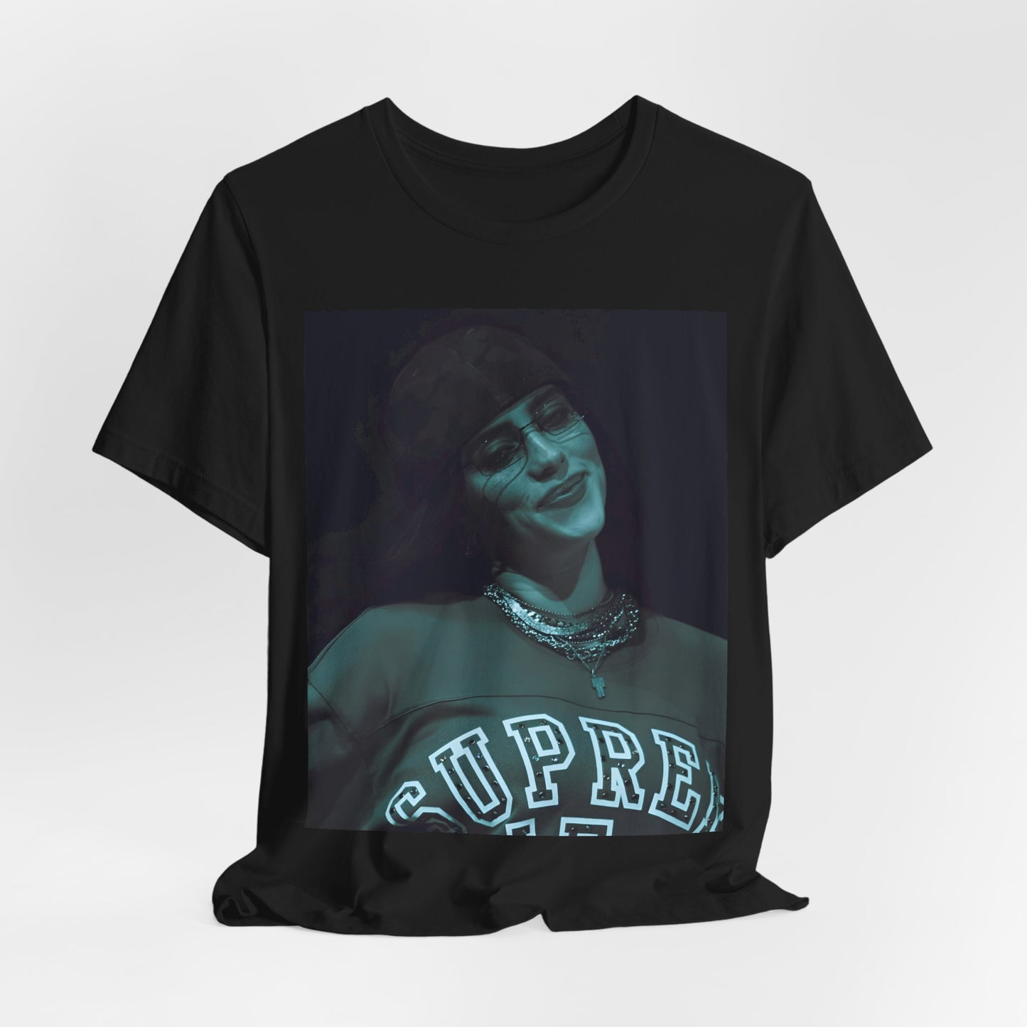A powerful, close-up portrait of Billie Eilish with a direct and intense stare, printed on a graphic t-shirt.