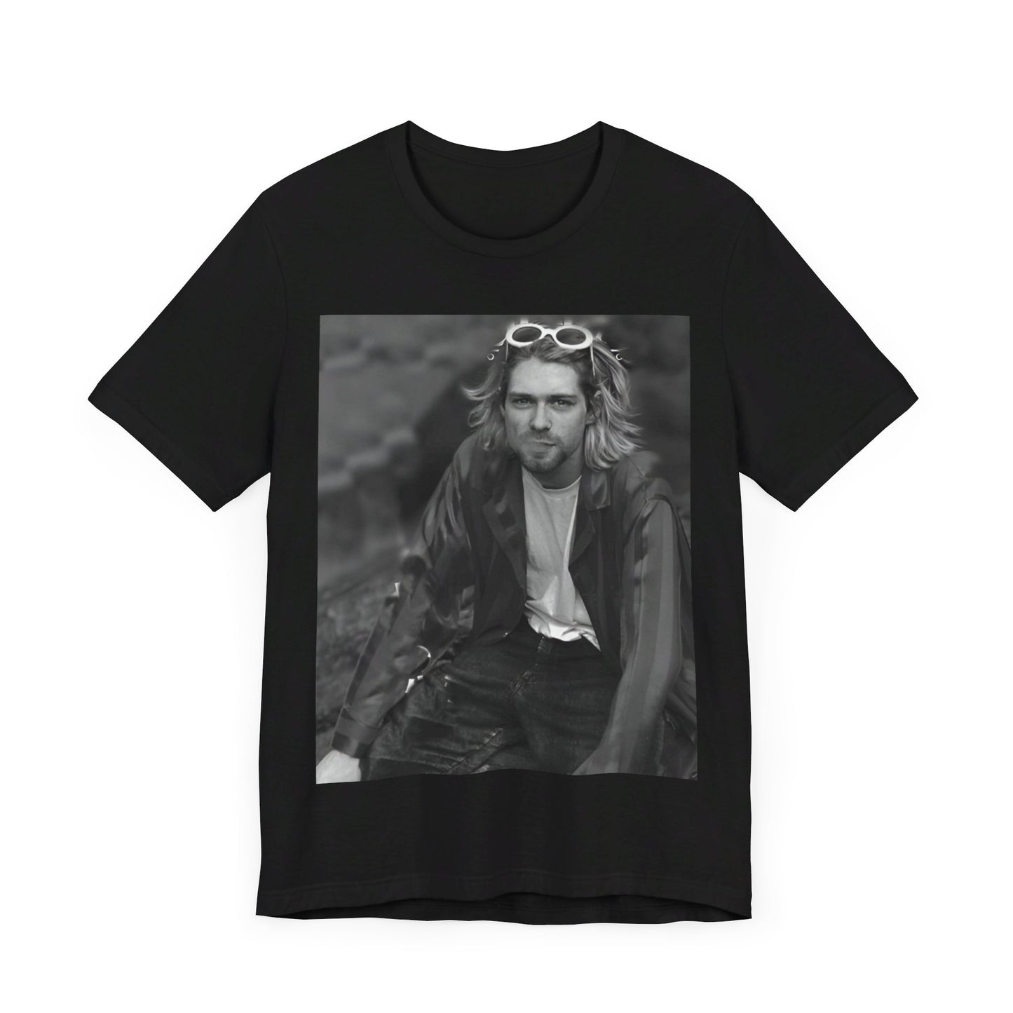 A black graphic t-shirt featuring a 90s black and white photo portrait of Kurt Cobain from Nirvana.