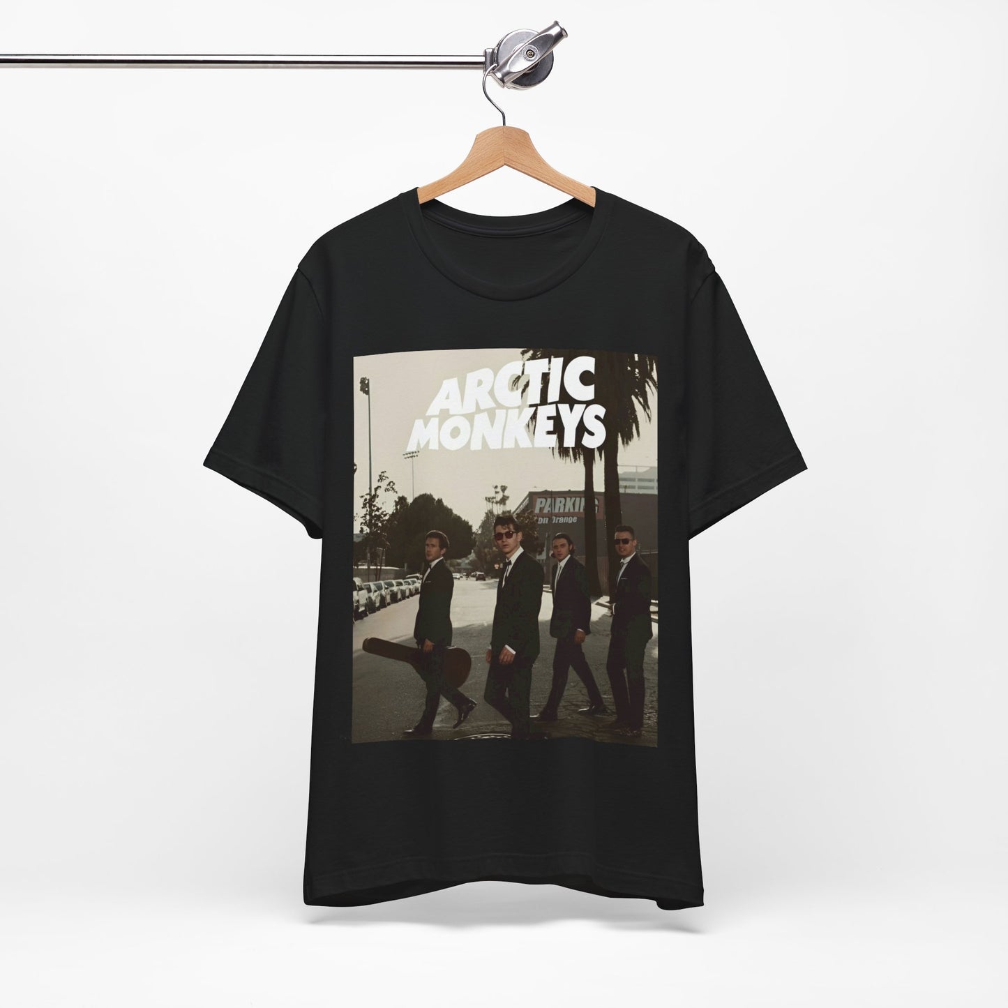 A black graphic t-shirt featuring Arctic Monkeys in a pose or setting similar to the iconic 'Abbey Road' album cover.