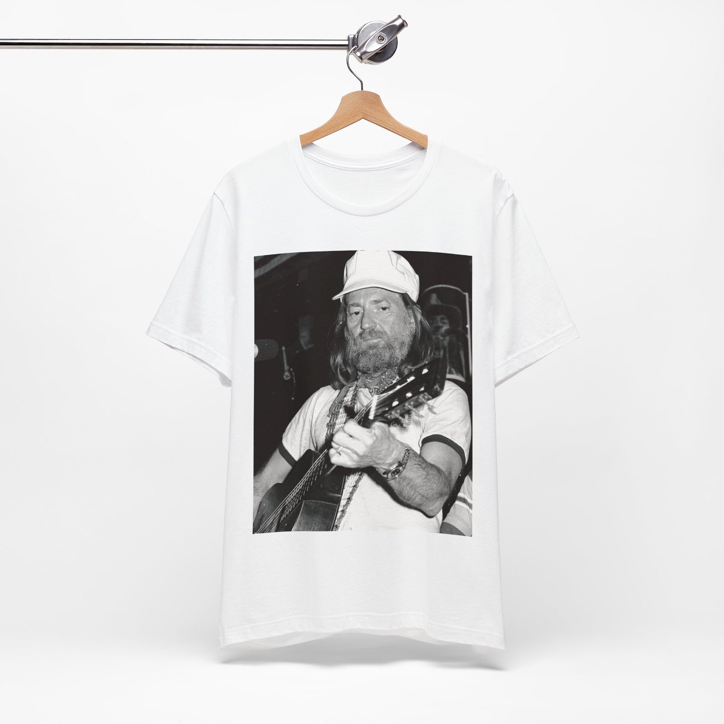 A black graphic t-shirt featuring a 70s cool free spirit graphic of Willie Nelson.