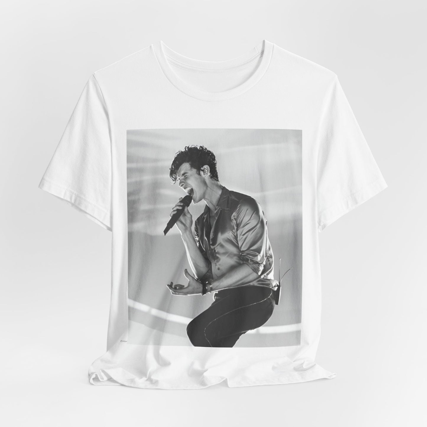 A black graphic t-shirt featuring a black and white graphic or photo of Shawn Mendes as a dreamy pop star.