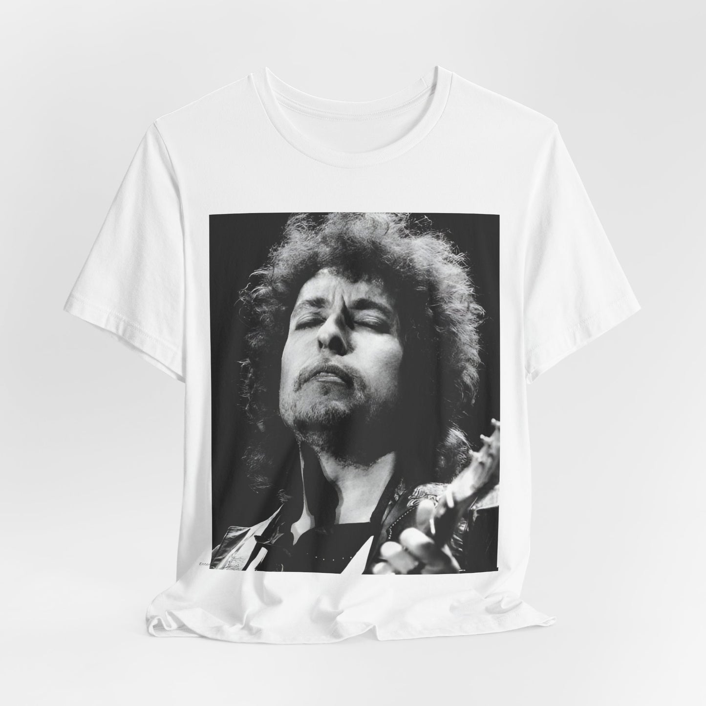 A black graphic t-shirt featuring a retro black and white graphic or photo of Bob Dylan performing live.