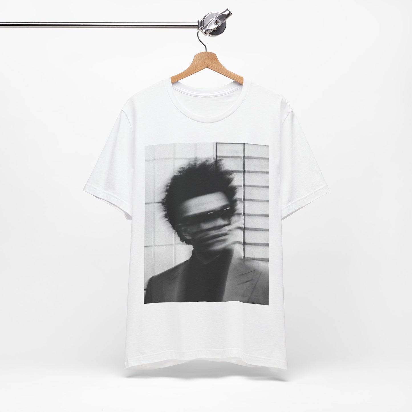 A black graphic t-shirt featuring a blurred graphic of The Weeknd from his 'After Hours' era.