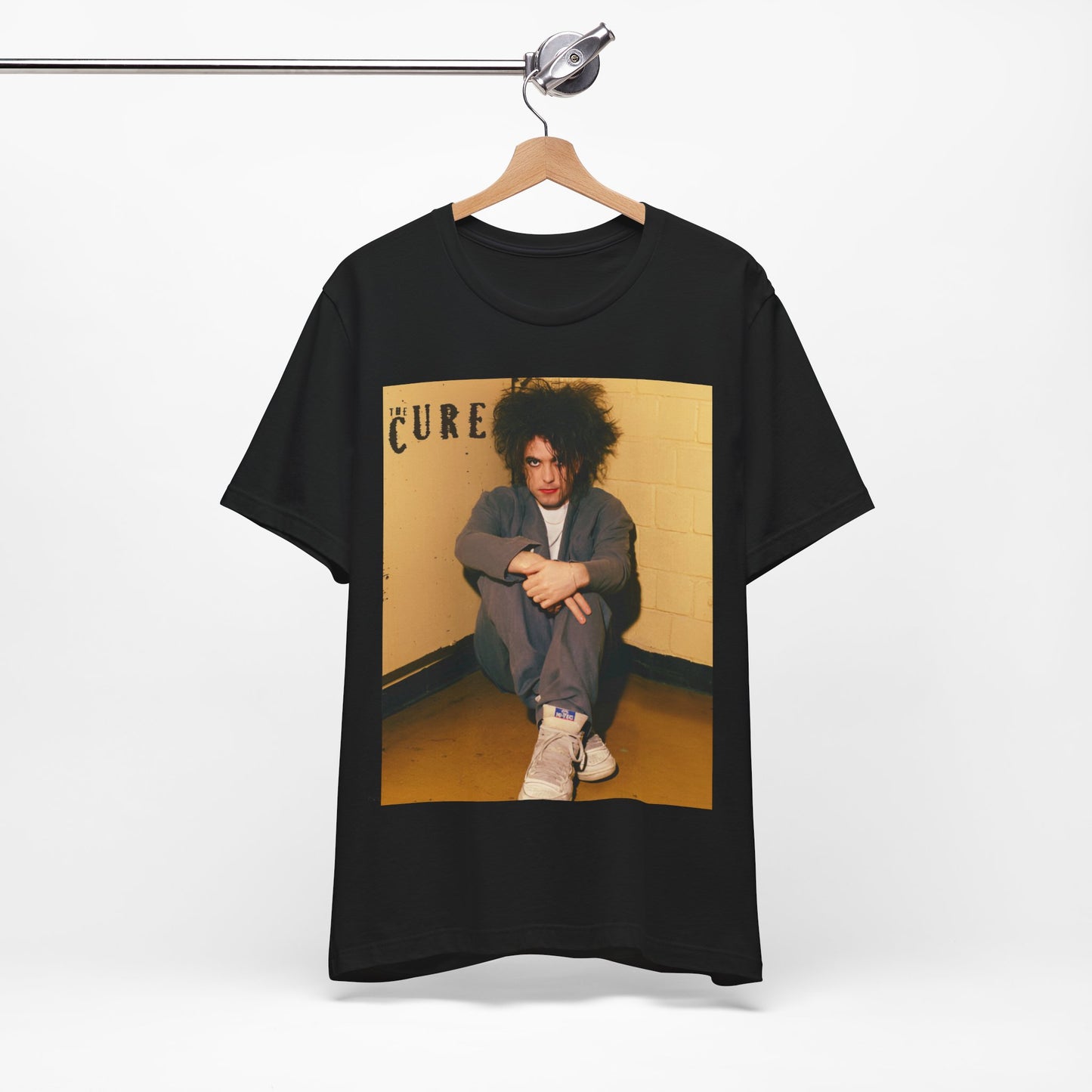 A black graphic t-shirt featuring a bold goth rock superstar graphic of The Cure.