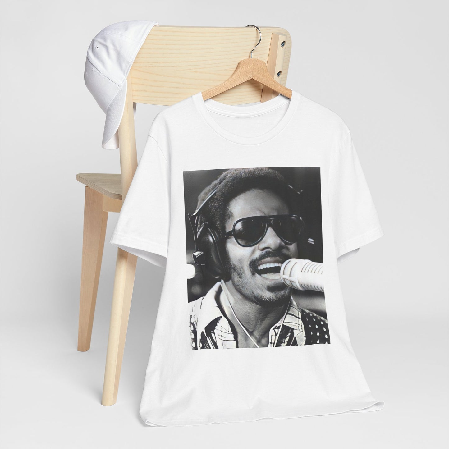 A black graphic t-shirt featuring a graphic of Stevie Wonder as a timeless visionary.