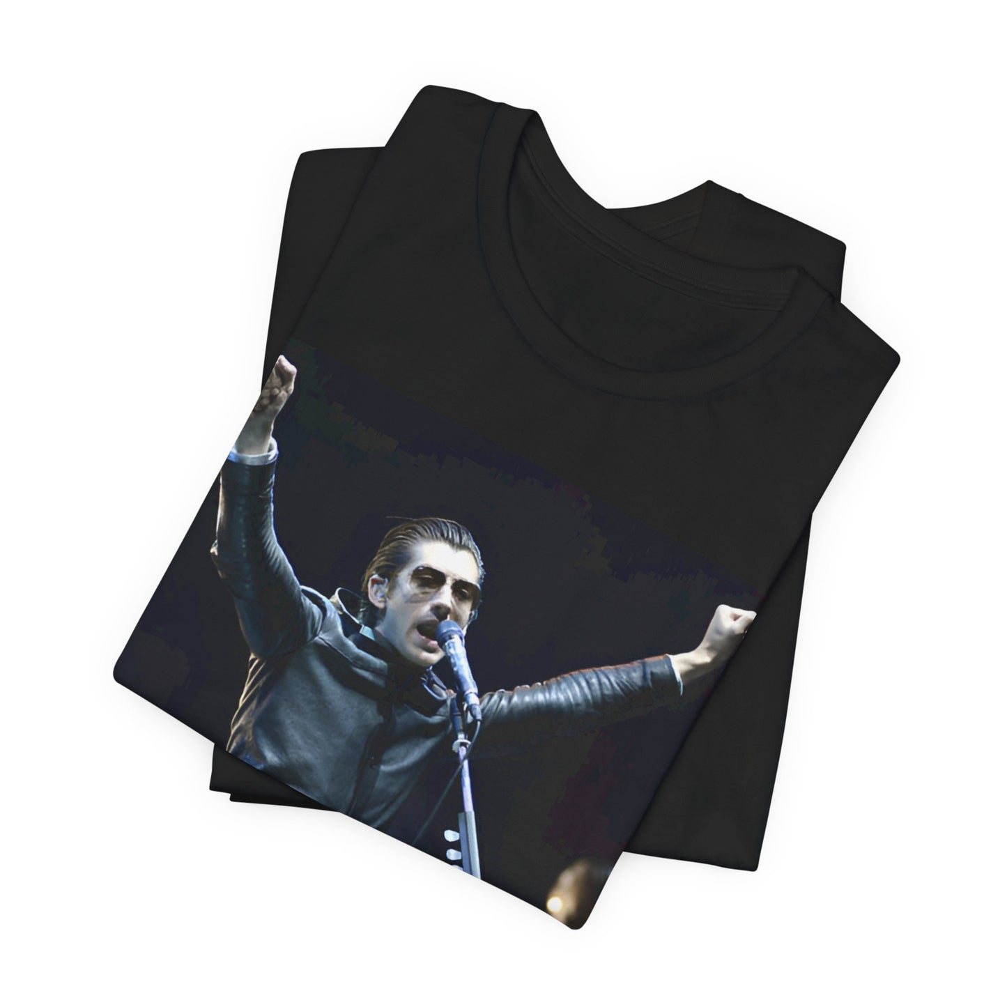 A black graphic t-shirt featuring a graphic or photo of Arctic Monkeys performing live on stage, with a Britpop aesthetic.