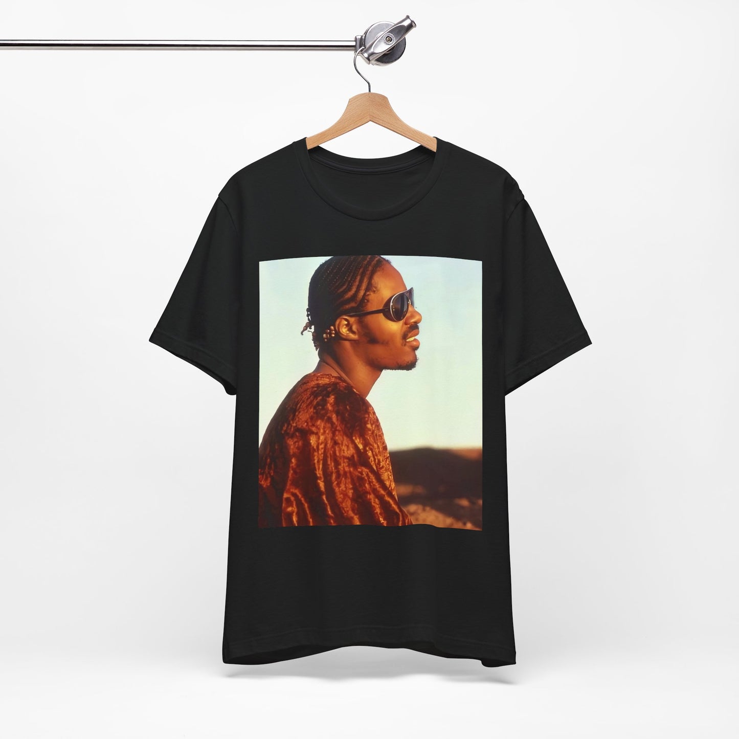 A black graphic t-shirt featuring a graphic of Stevie Wonder as an iconic style pop innovator.