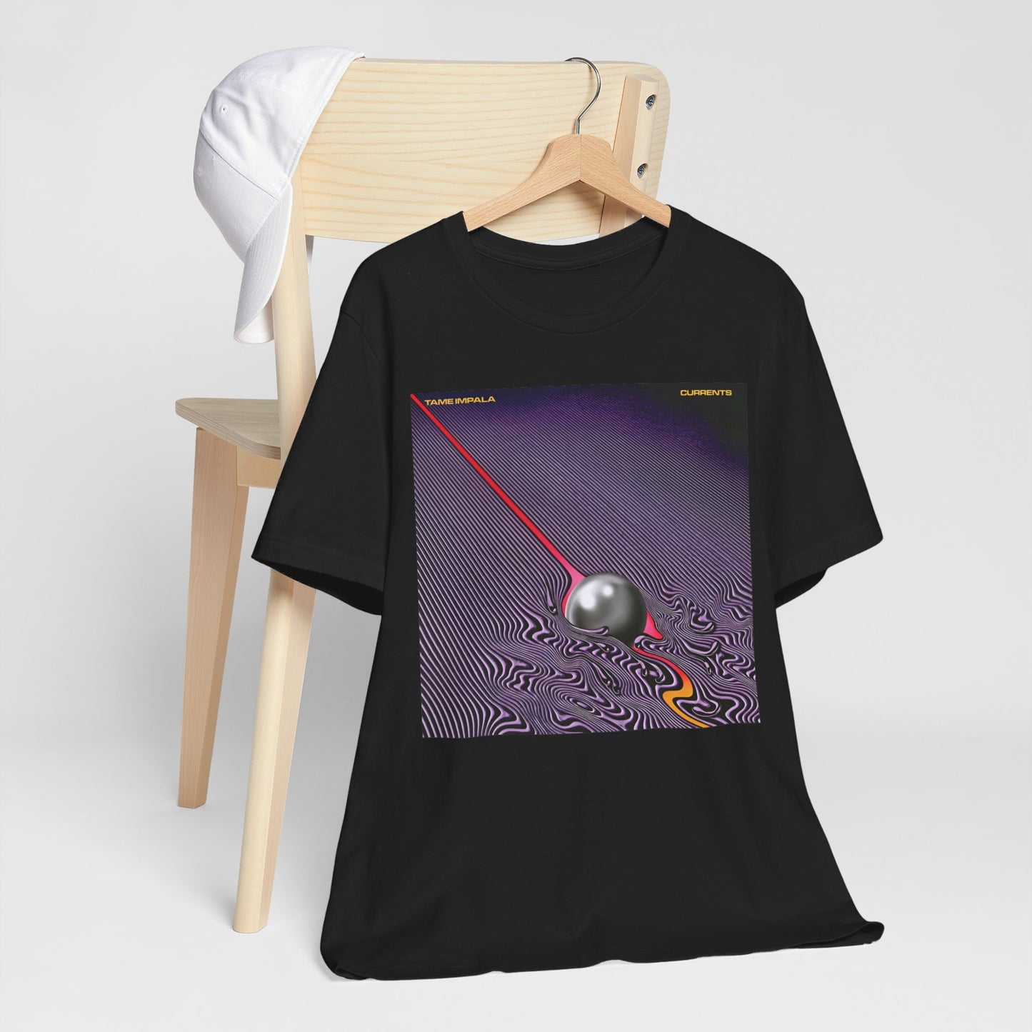 A black graphic t-shirt featuring a graphic related to Tame Impala's 'Currents' album.