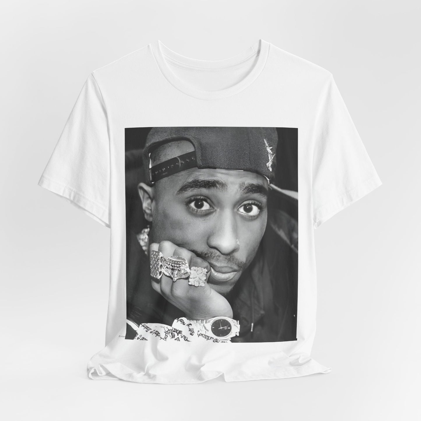 A black graphic t-shirt featuring a bold graphic of Tupac as a rap superstar.