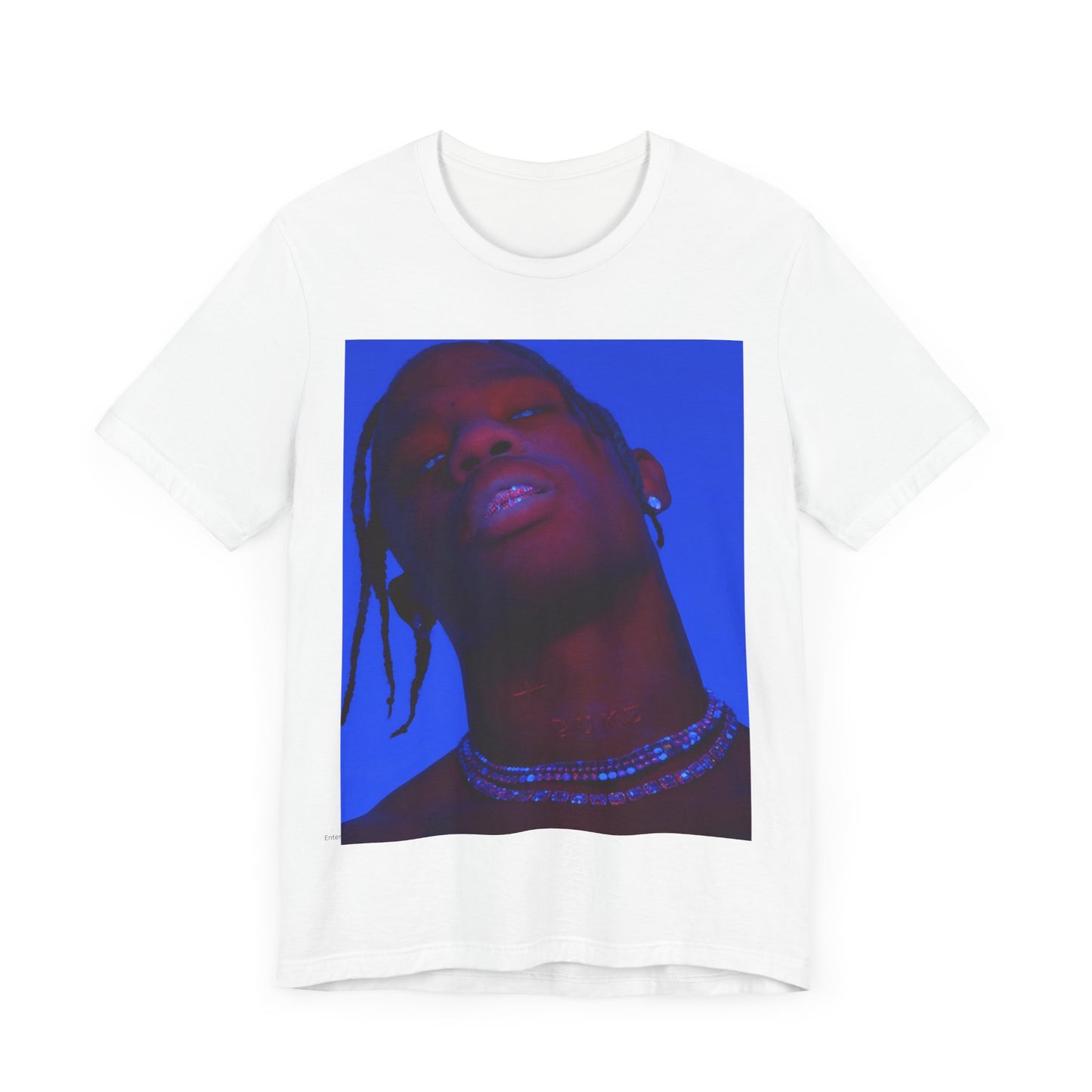 A black graphic t-shirt featuring a bold graphic of Travis Scott as a rap superstar.