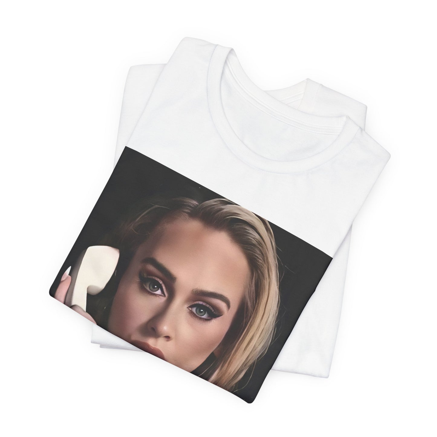 A black graphic t-shirt featuring a black and white candid photo of Adele with a phone to her ear, showing a thoughtful or emotional expression.