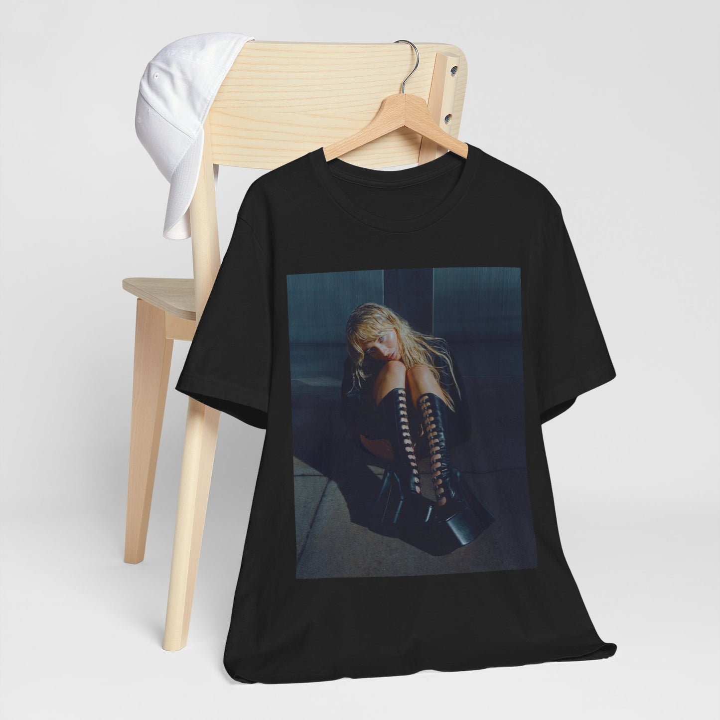 A black graphic t-shirt featuring a bold graphic of Sabrina Carpenter as a pop superstar.