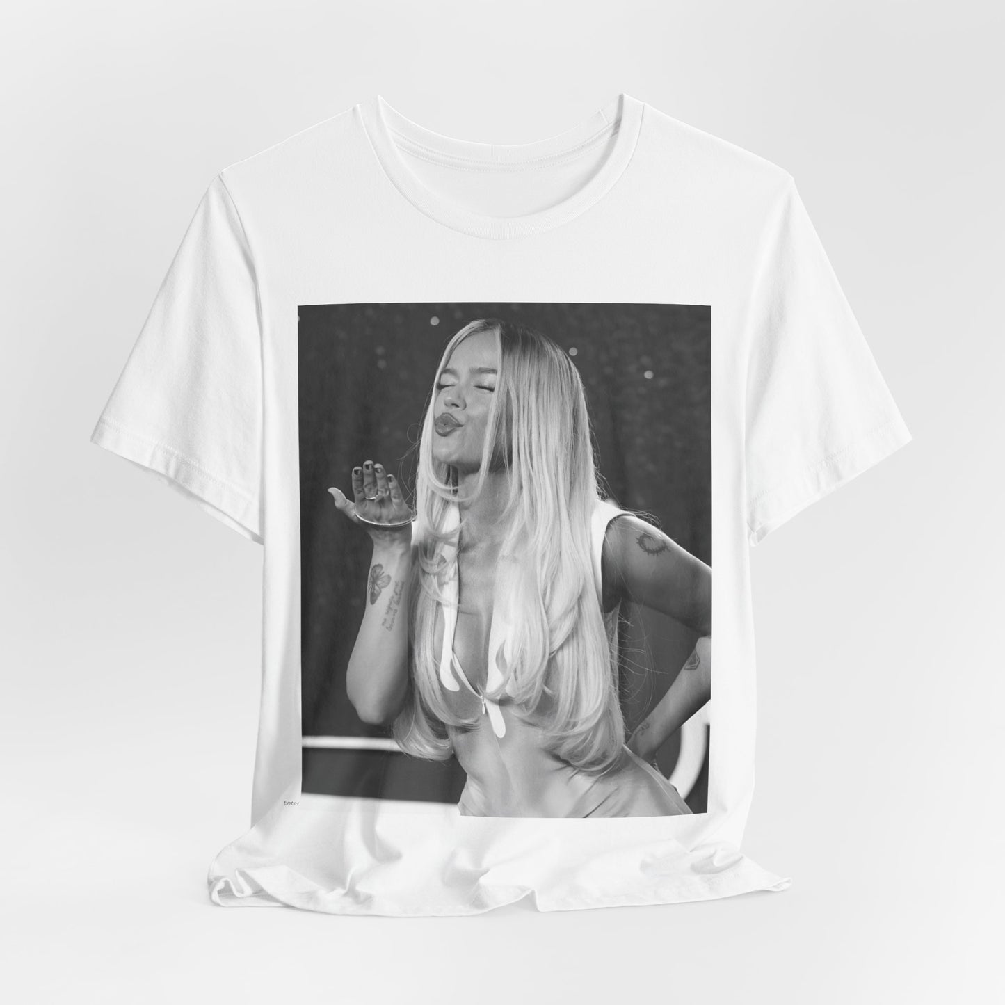 A black graphic t-shirt featuring a graphic of Karol G with a 'La Bichota Kiss' theme.