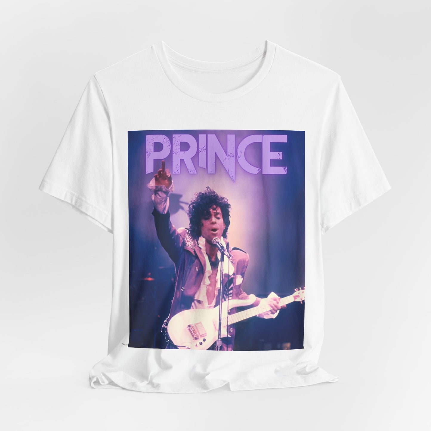 A black graphic t-shirt featuring a retro graphic related to Prince's 'Purple Rain' album era.