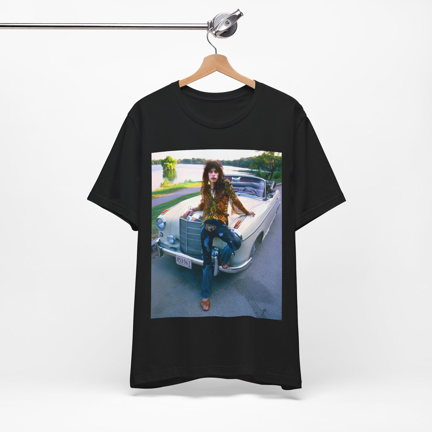 A black graphic t-shirt featuring a retro 70s photo of Aerosmith band members in a bohemian style, posing with a classic Mercedes car.