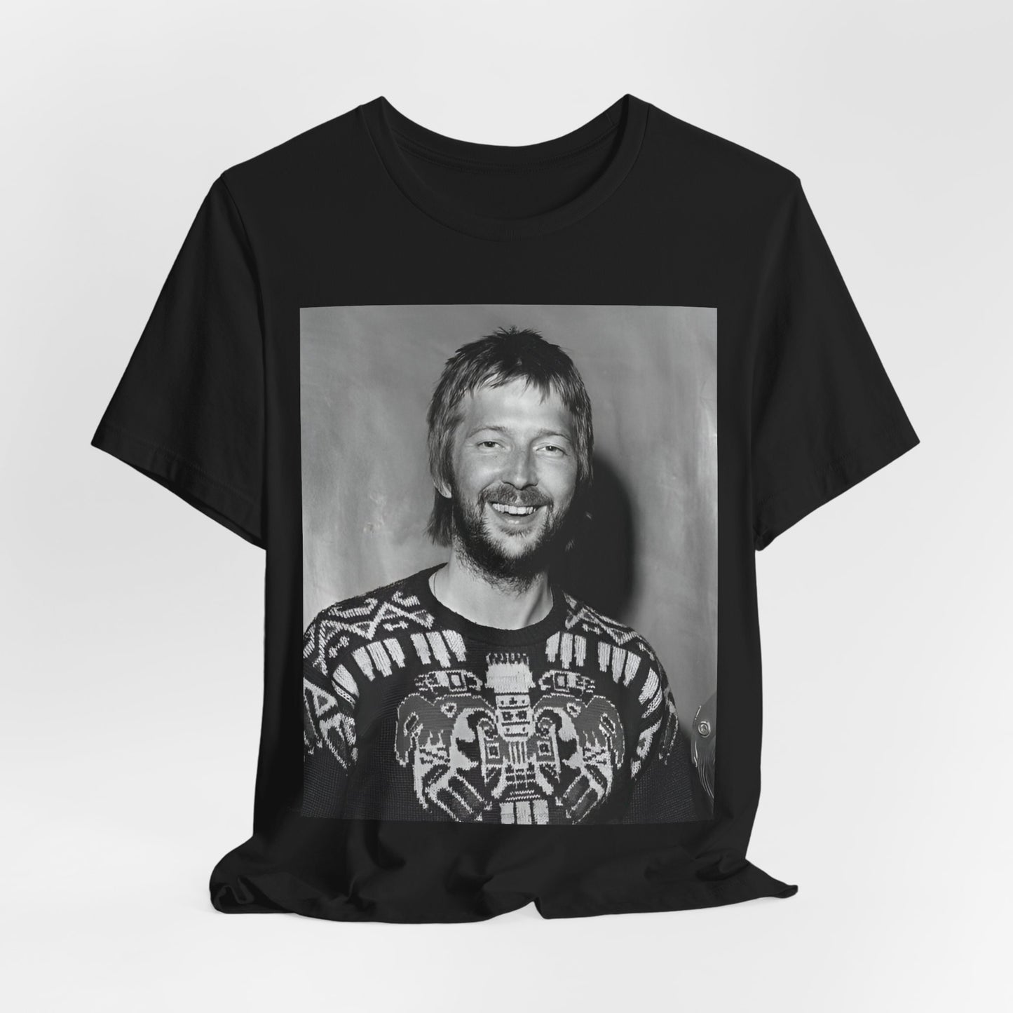 A black graphic t-shirt featuring a 70s photo portrait of Eric Clapton.