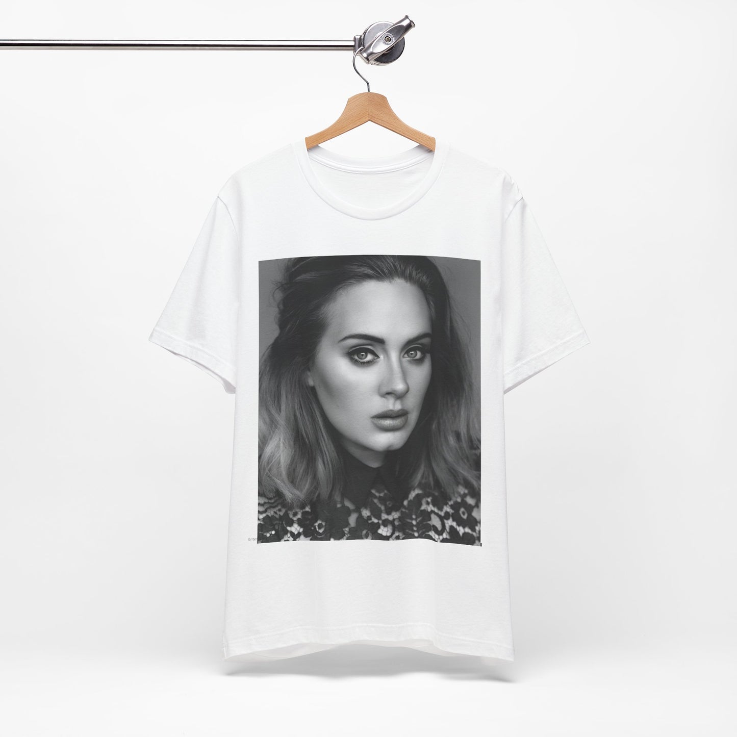 A black graphic t-shirt featuring a classic black and white, monochrome portrait of Adele, showing her with a serene or thoughtful expression.