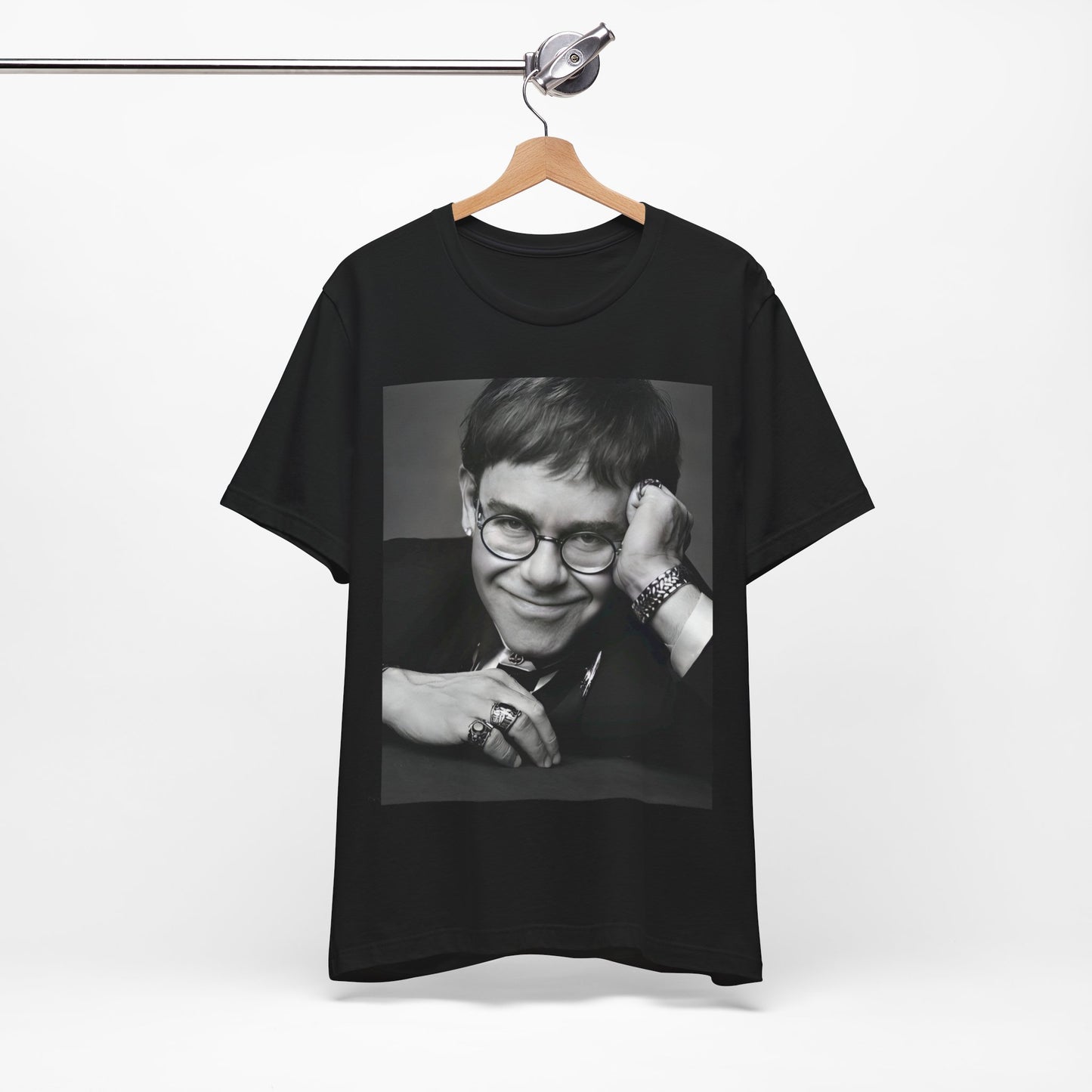 A black graphic t-shirt featuring a retro black and white photo portrait of Elton John.