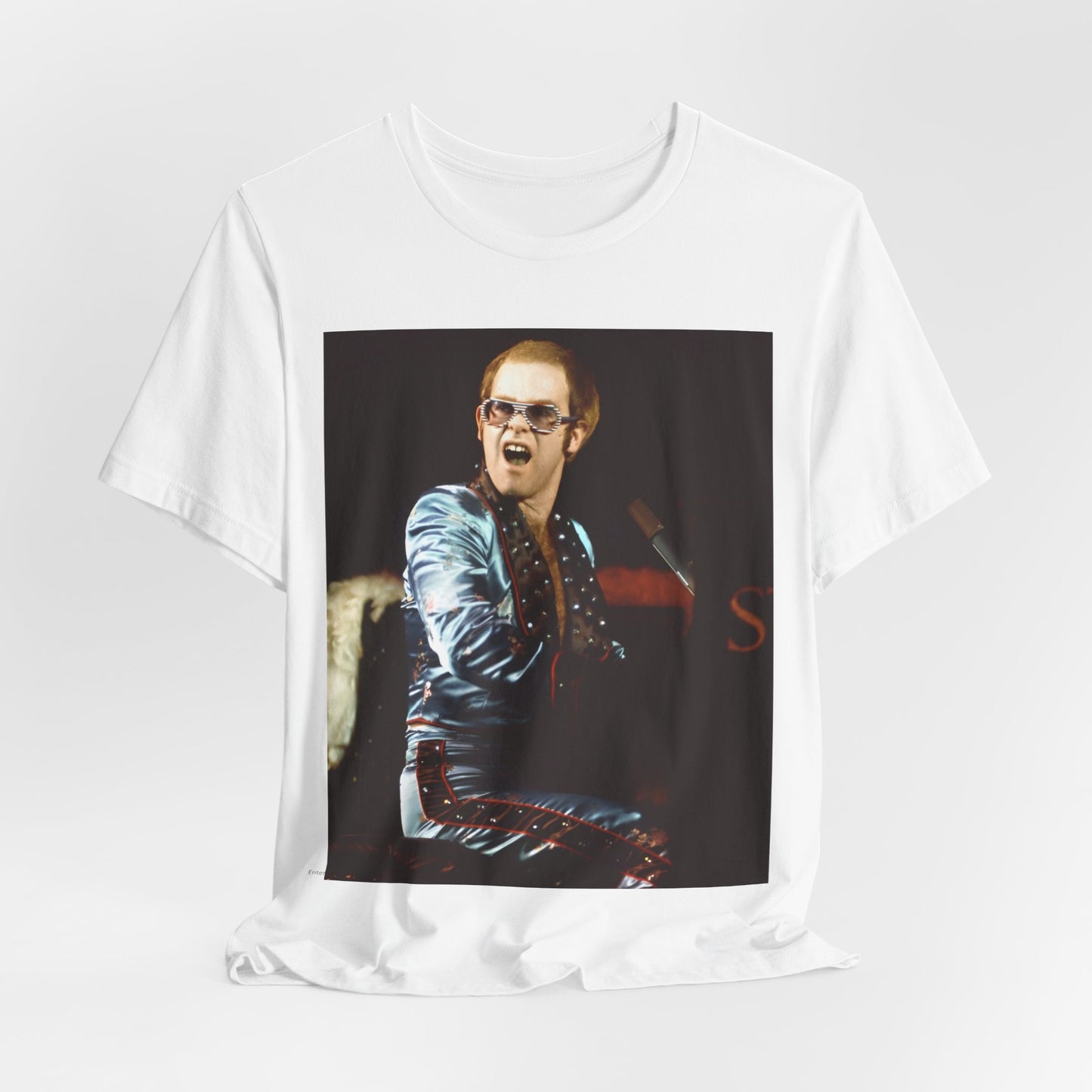 A black graphic t-shirt featuring a retro graphic related to Elton John's 'Rocket Man' song or era.