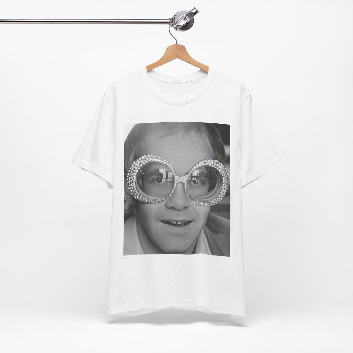 A black graphic t-shirt featuring a graphic of Elton John emphasizing his iconic glasses and fashion.