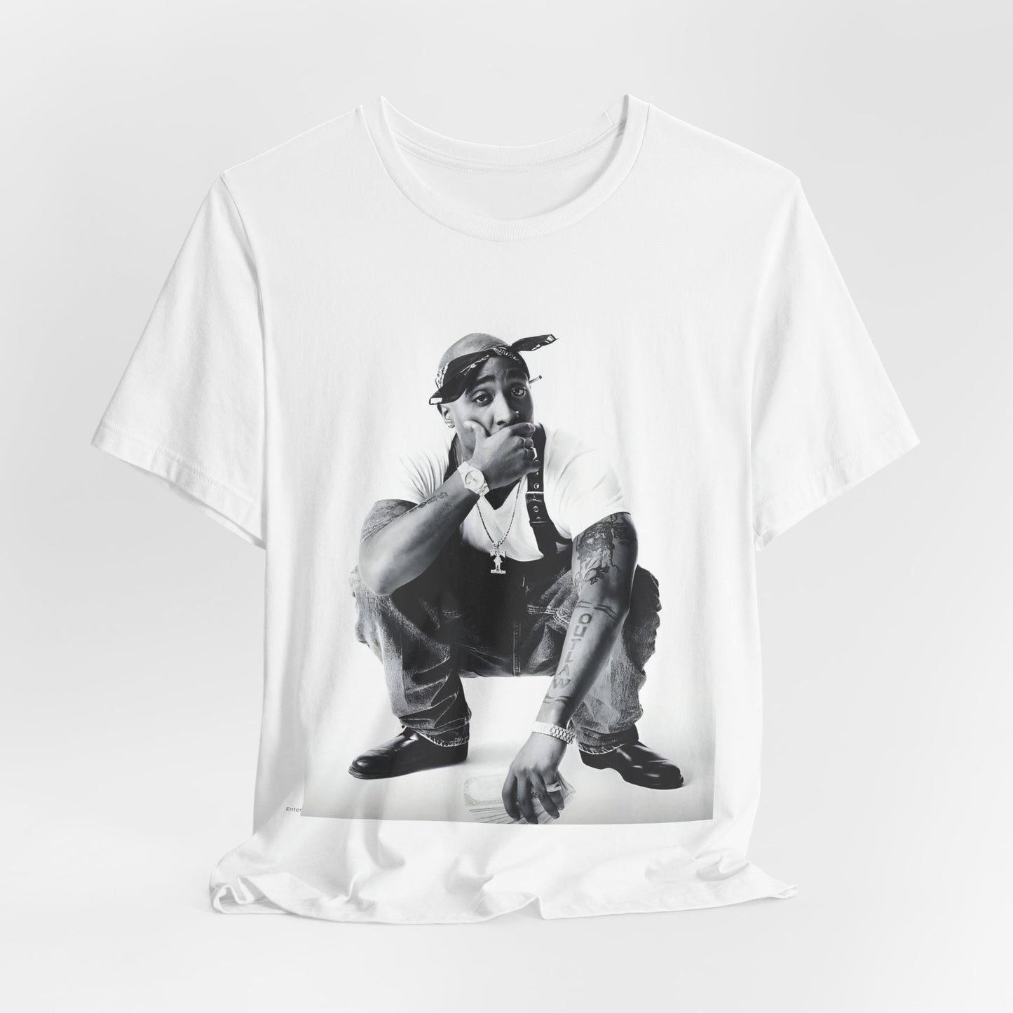 A black graphic t-shirt featuring a graphic of Tupac with a conscious rap vibe.