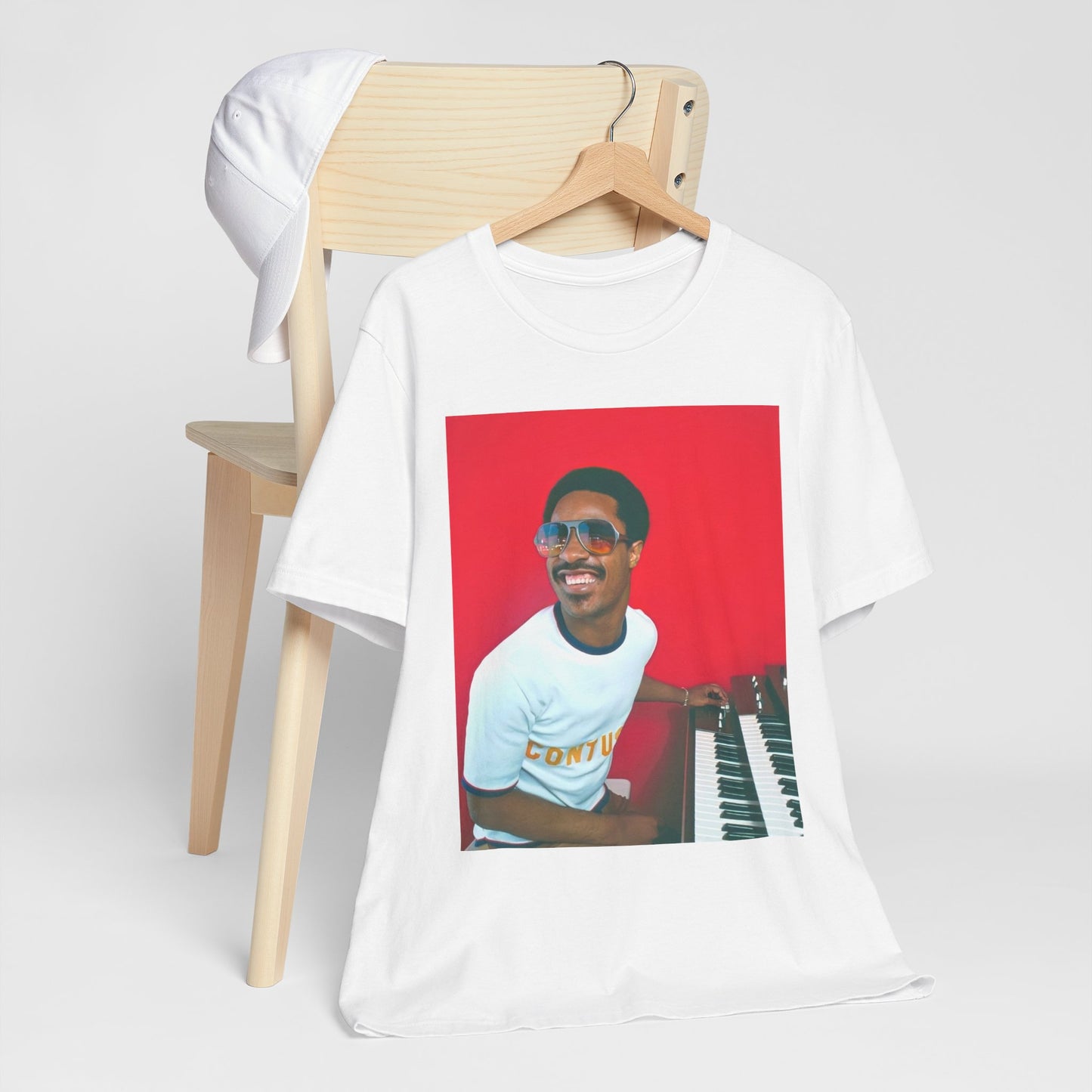 A black graphic t-shirt featuring a graphic of Stevie Wonder with a piano.