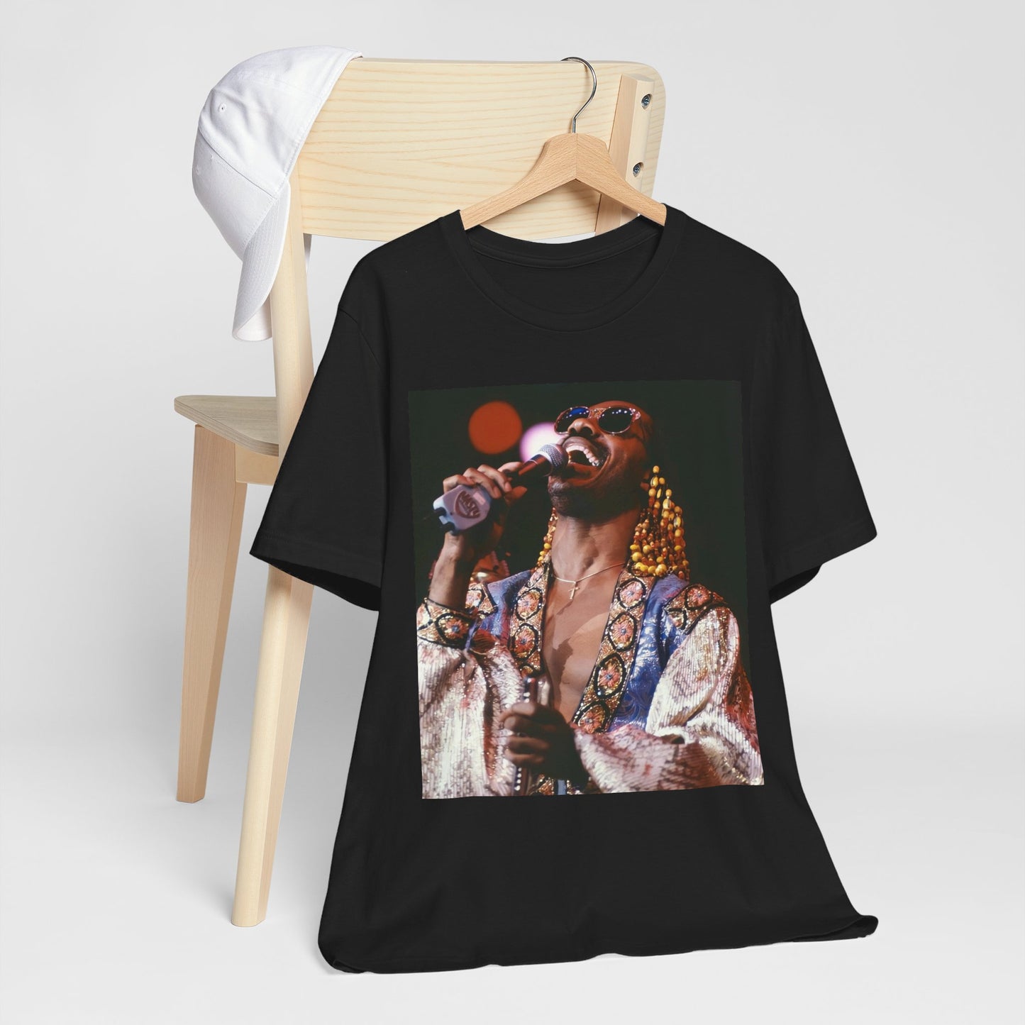 A black graphic t-shirt featuring a 70s vintage soul icon graphic of Stevie Wonder.