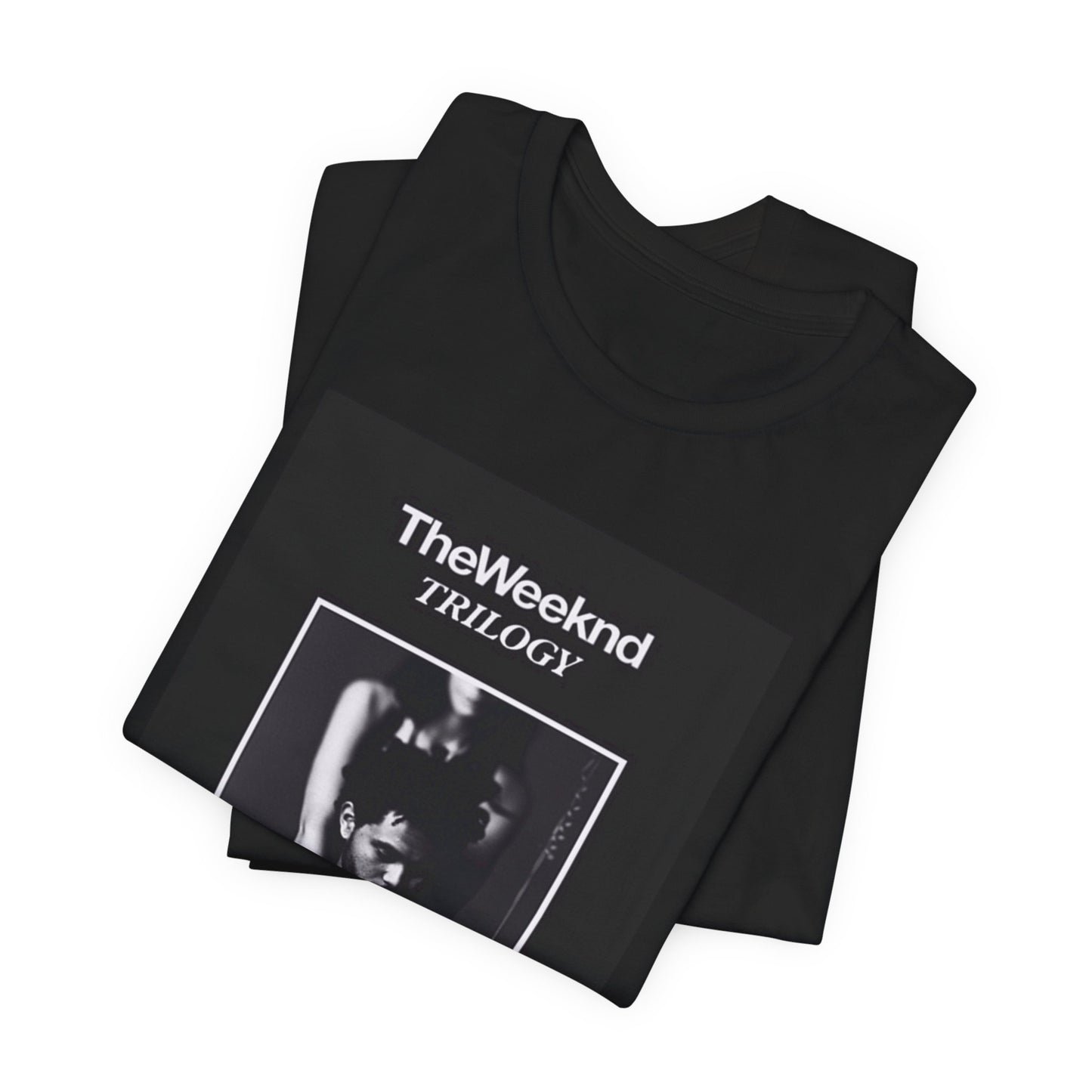 A black graphic t-shirt featuring a graphic related to The Weeknd's 'Trilogy' album.