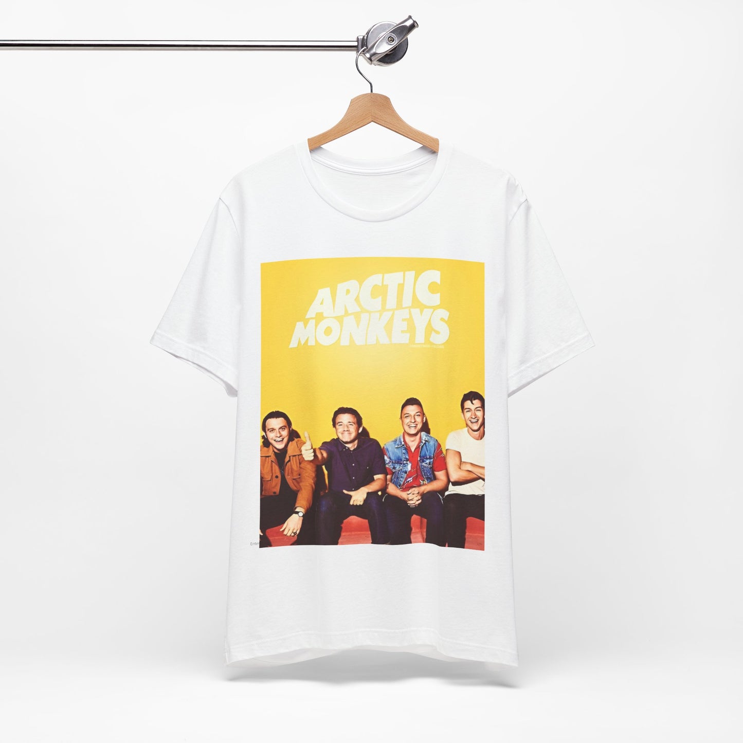A black graphic t-shirt featuring a bold, vintage-style graphic for the Arctic Monkeys, possibly with abstract elements or stylized band imagery.